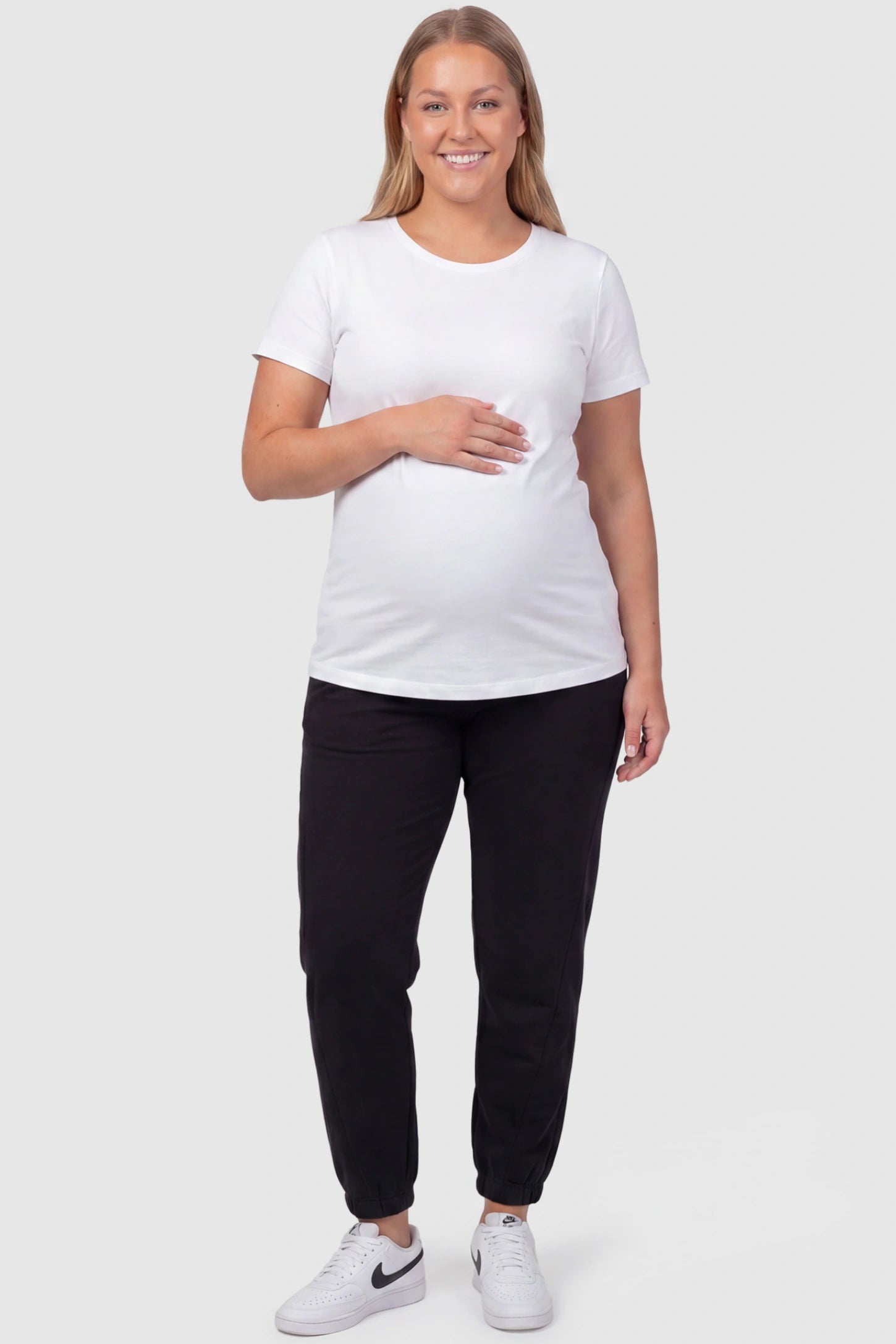 Full Panel Pocketed Maternity Jogger Pants Full Panel Pocketed Maternity Jogger Pants in Black featuring a jersey belly panel on a plus size pregnant model, front view.