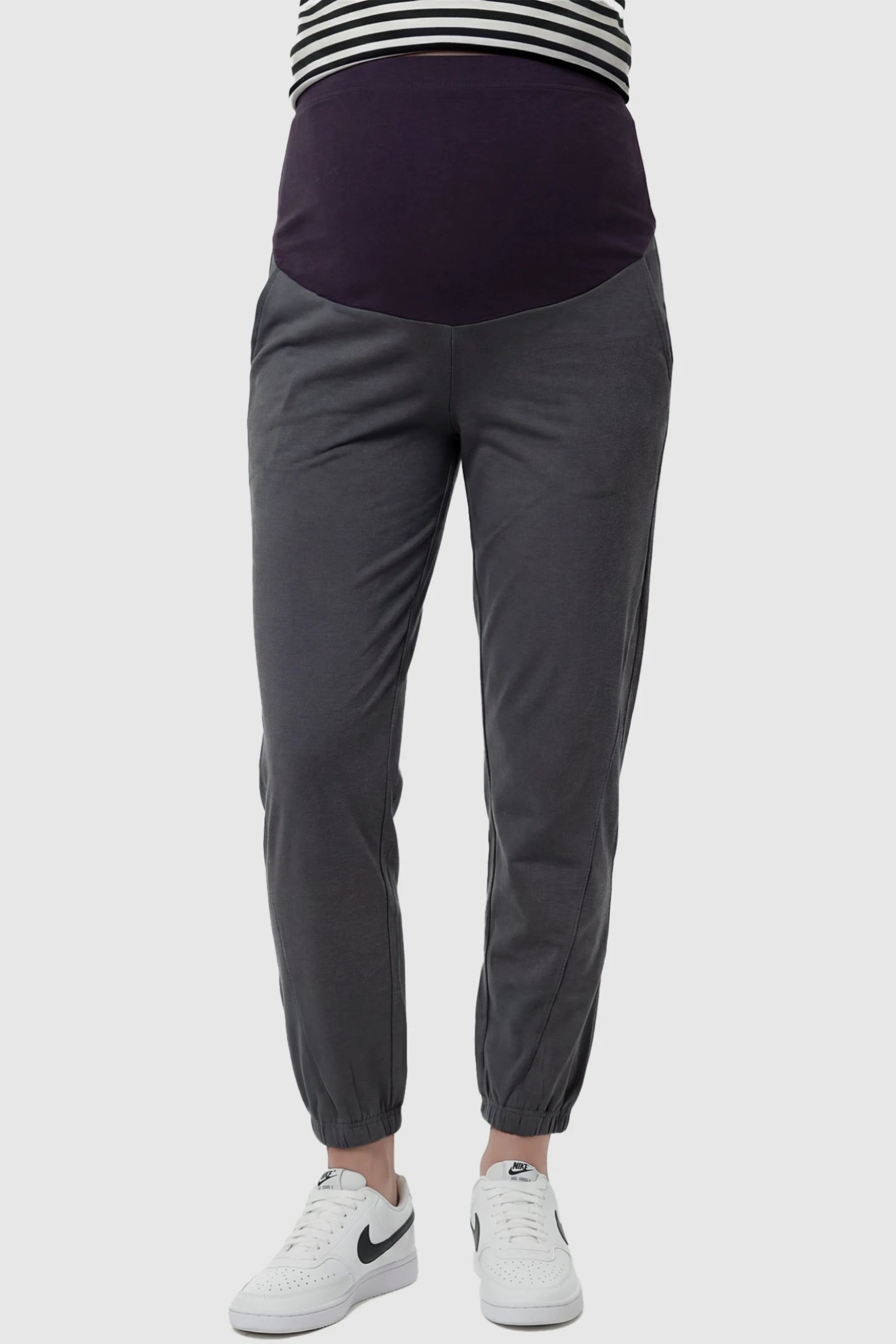Full Panel Pocketed Maternity Jogger Pants Full Panel Pocketed Maternity Jogger Pants in Dark Gray featuring a jersey belly panel on a pregnant model, front view.