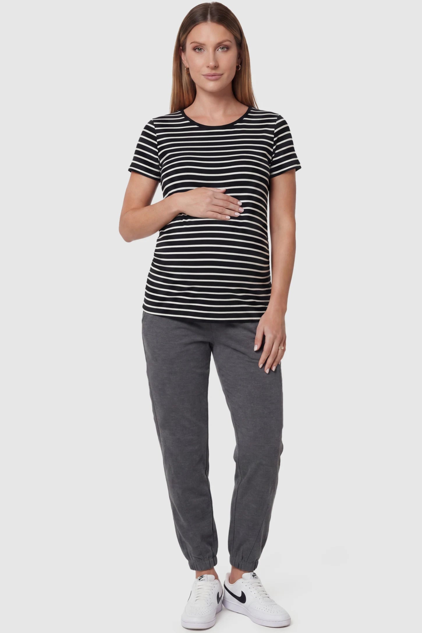 Full Panel Pocketed Maternity Jogger Pants Full Panel Pocketed Maternity Jogger Pants in Dark Gray featuring a jersey belly panel on a pregnant model, front view.