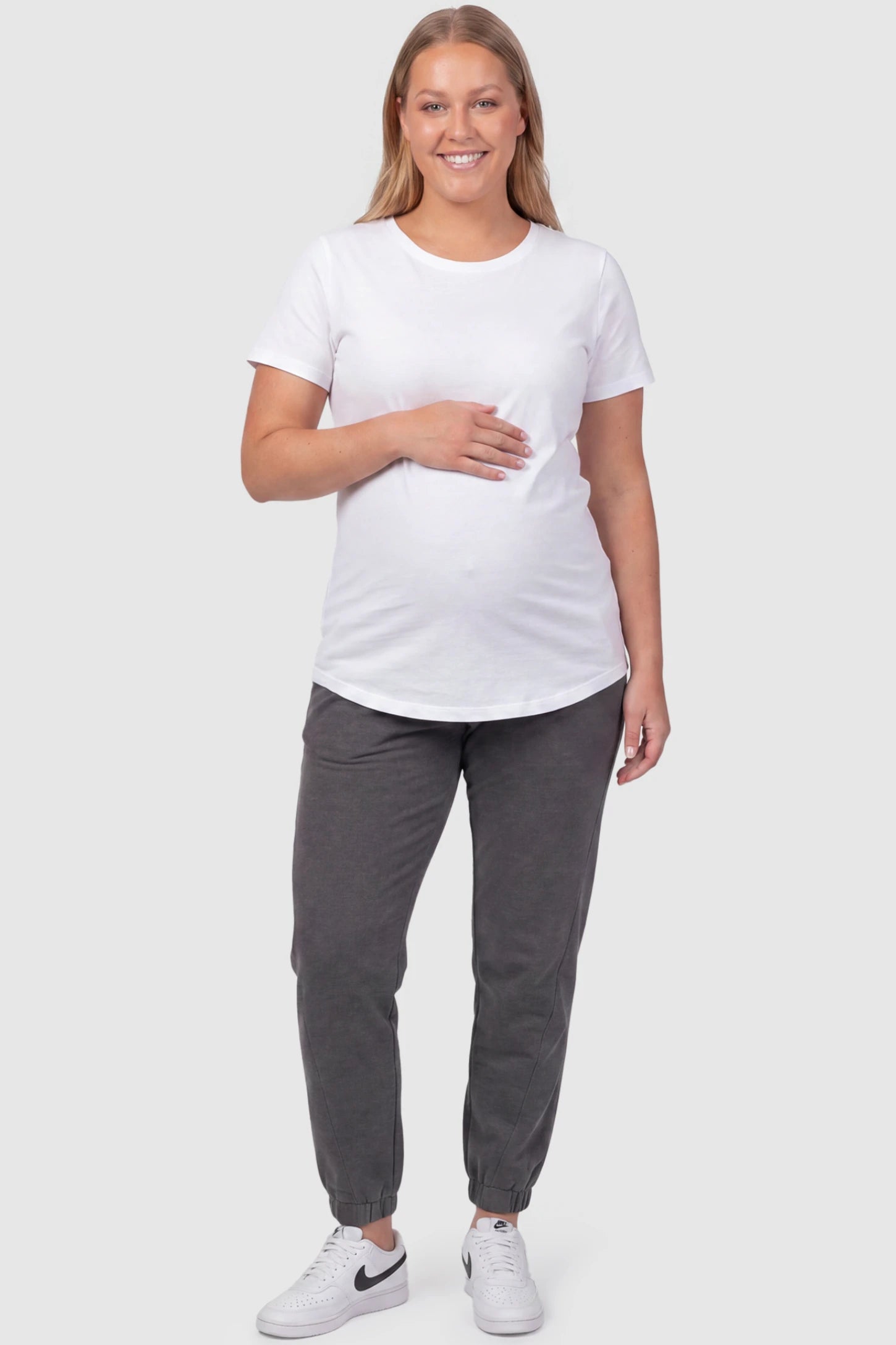 Full Panel Pocketed Maternity Jogger Pants Full Panel Pocketed Maternity Jogger Pants in Dark Gray featuring a jersey belly panel on a plus size pregnant model, front view.