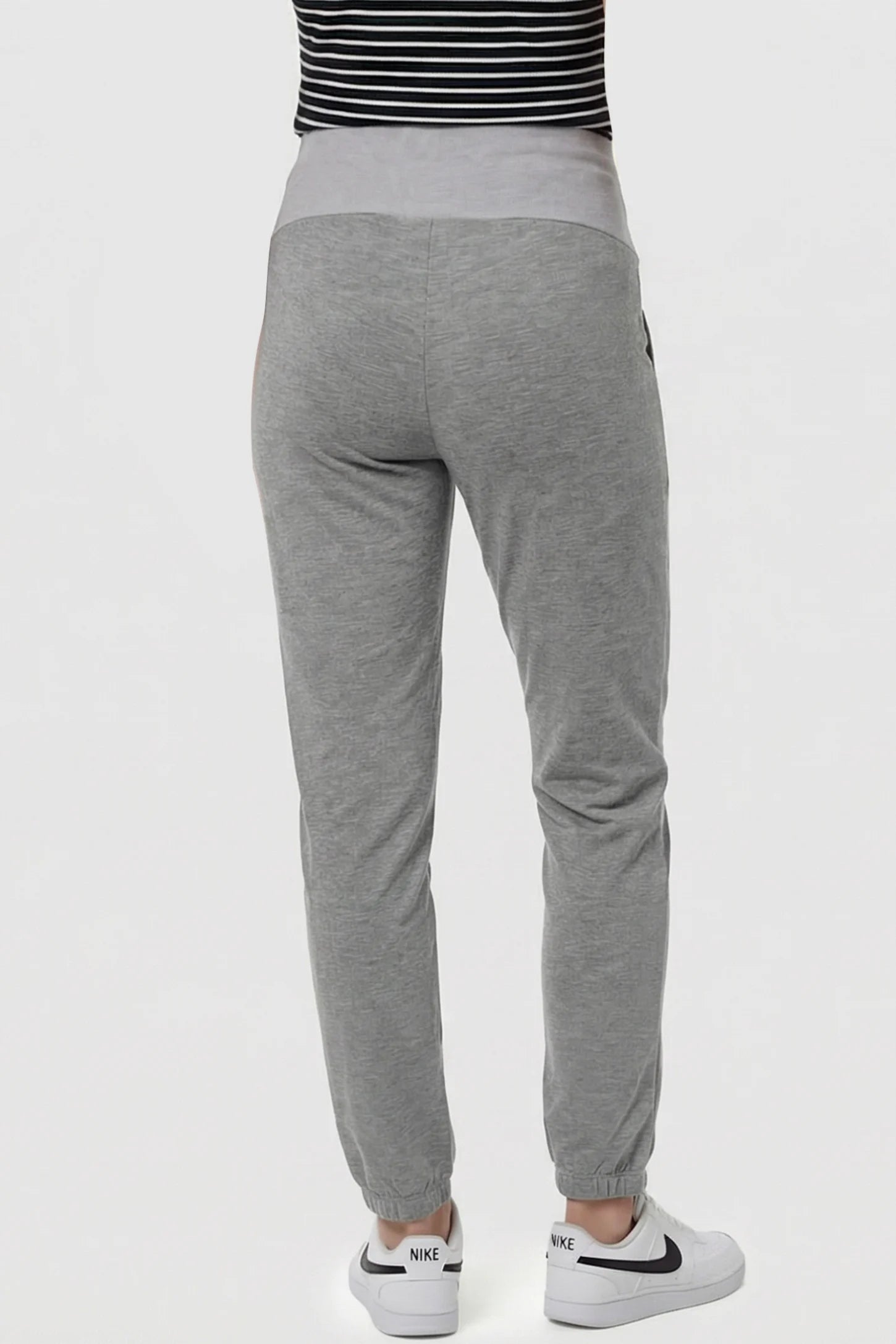 Full Panel Pocketed Maternity Jogger Pants Full Panel Pocketed Maternity Jogger Pants in Light Gray featuring lightweight, slight stretch fabric on a pregnant model, back view.