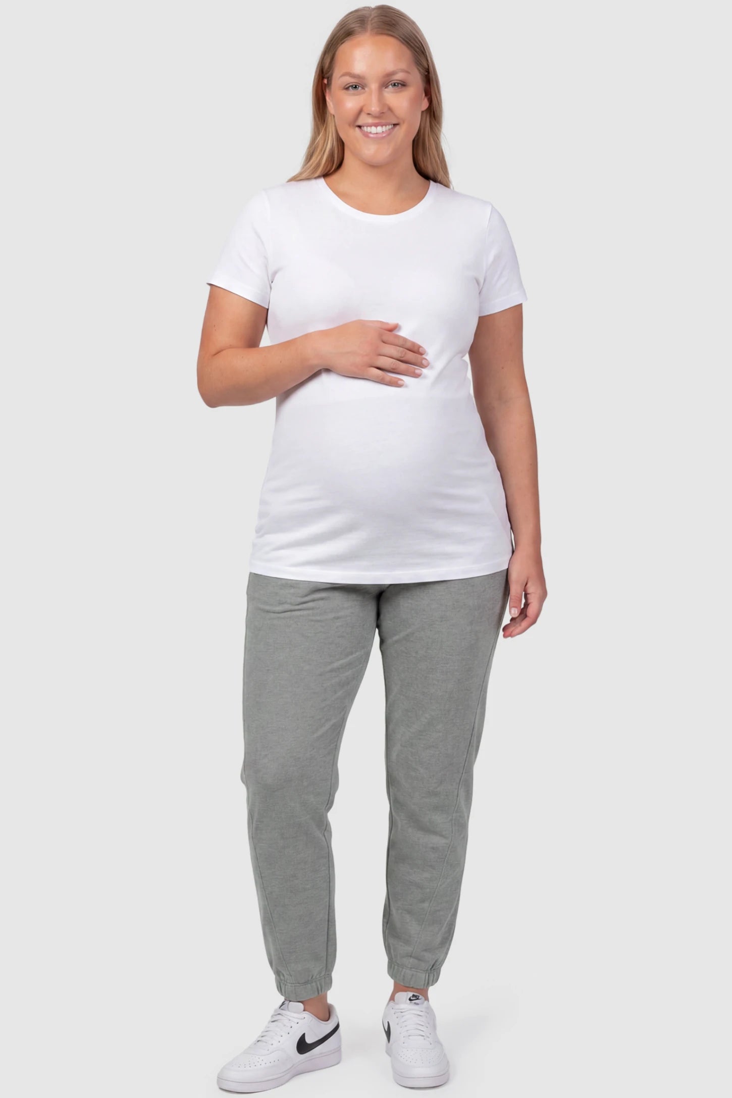 Full Panel Pocketed Maternity Jogger Pants Full Panel Pocketed Maternity Jogger Pants in Light Gray featuring a jersey belly panel on a plus size pregnant model, front view.