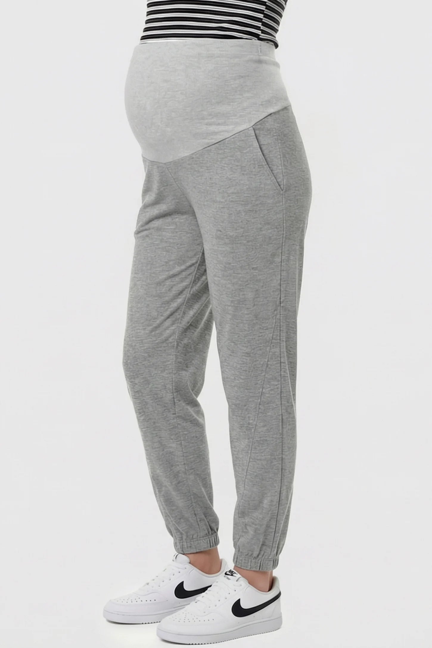 Full Panel Pocketed Maternity Jogger Pants Full Panel Pocketed Maternity Jogger Pants in Light Gray featuring a jersey belly panel on a pregnant model, side view.