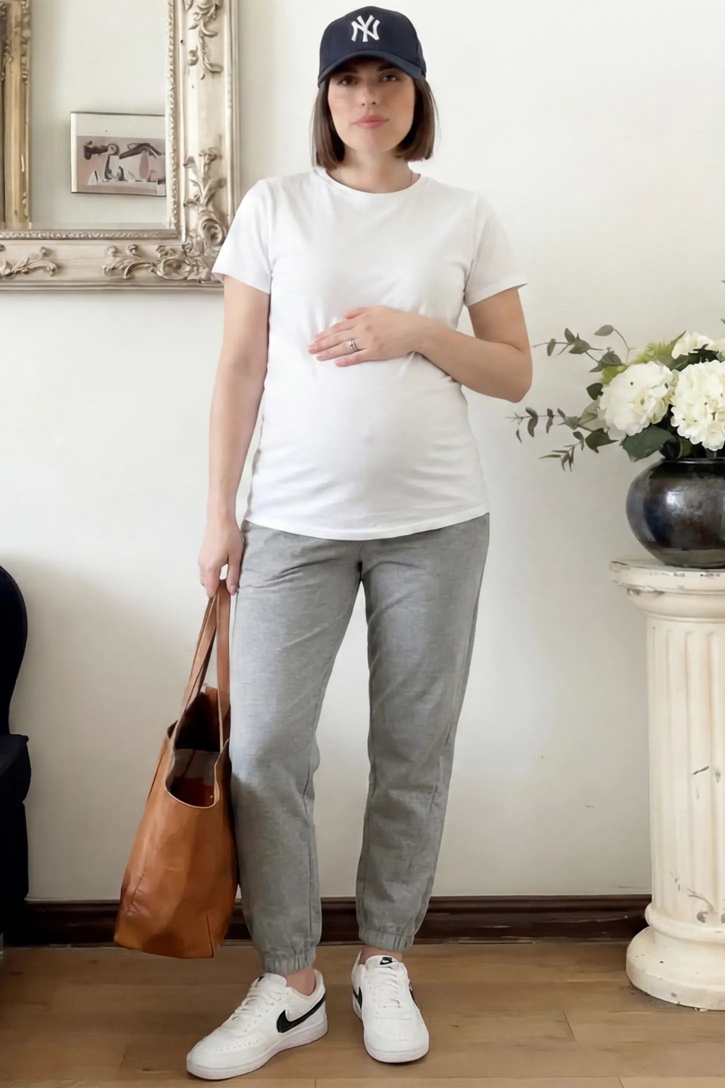 Full Panel Pocketed Maternity Jogger Pants Full Panel Pocketed Maternity Jogger Pants in Light Gray featuring a jersey belly panel on a pregnant woman in indoor setting, front view.