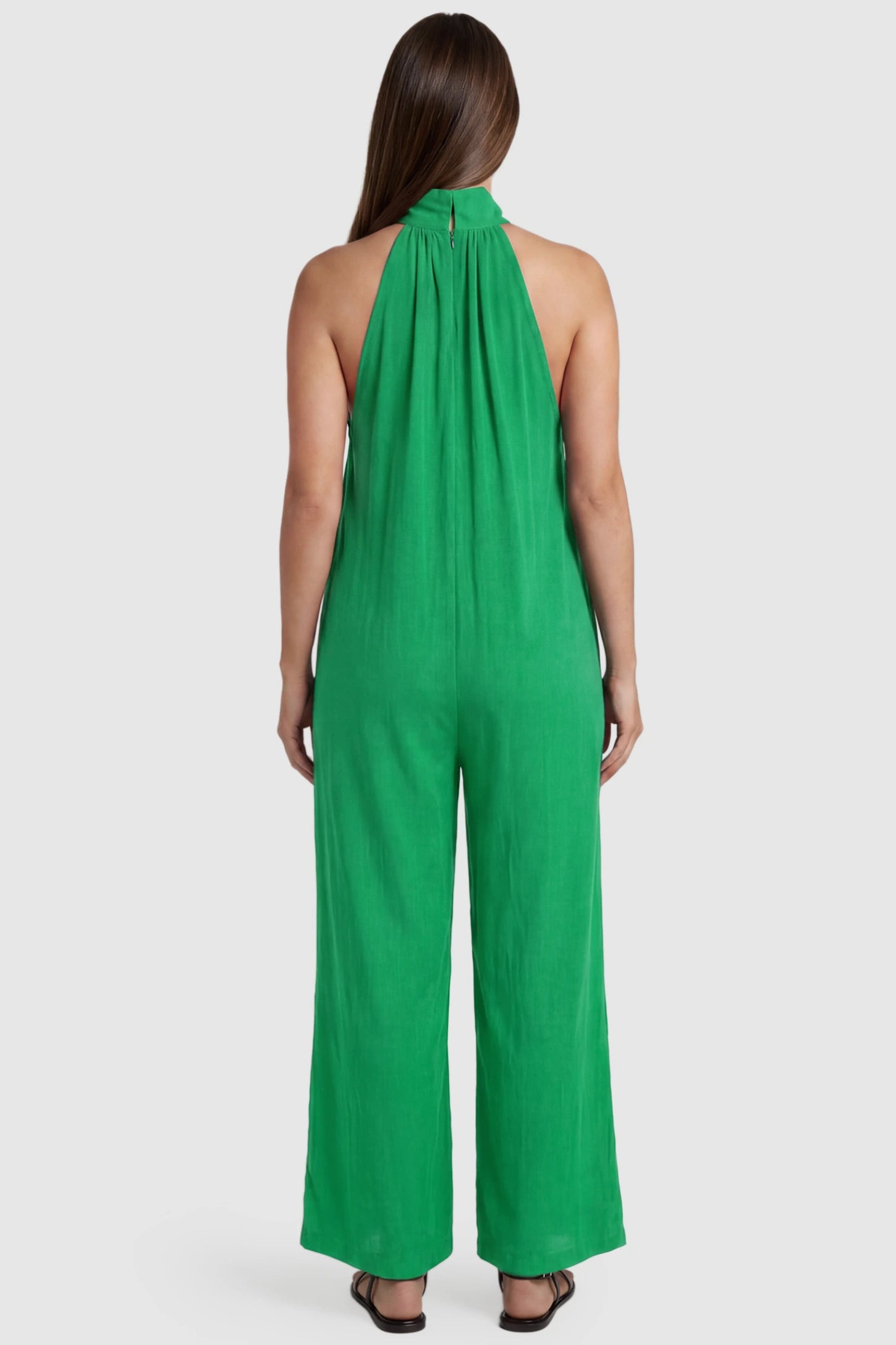 Pocketed Mock Neck Sleeveless Maternity Jumpsuit Pocketed Mock Neck Sleeveless Maternity Jumpsuit in green featuring a high gathered neckline, side pockets shown on a pregnant model, back view.
