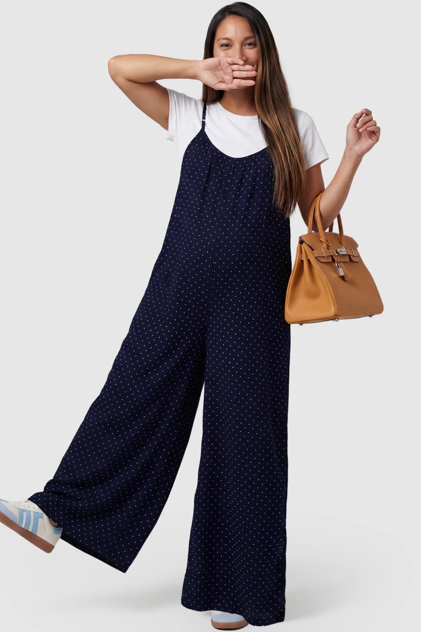 Pocketed Spaghetti Strap Wide Leg Maternity Jumpsuit in Blue featuring loose fitting silhouette and pockets on a pregnant model, front view.