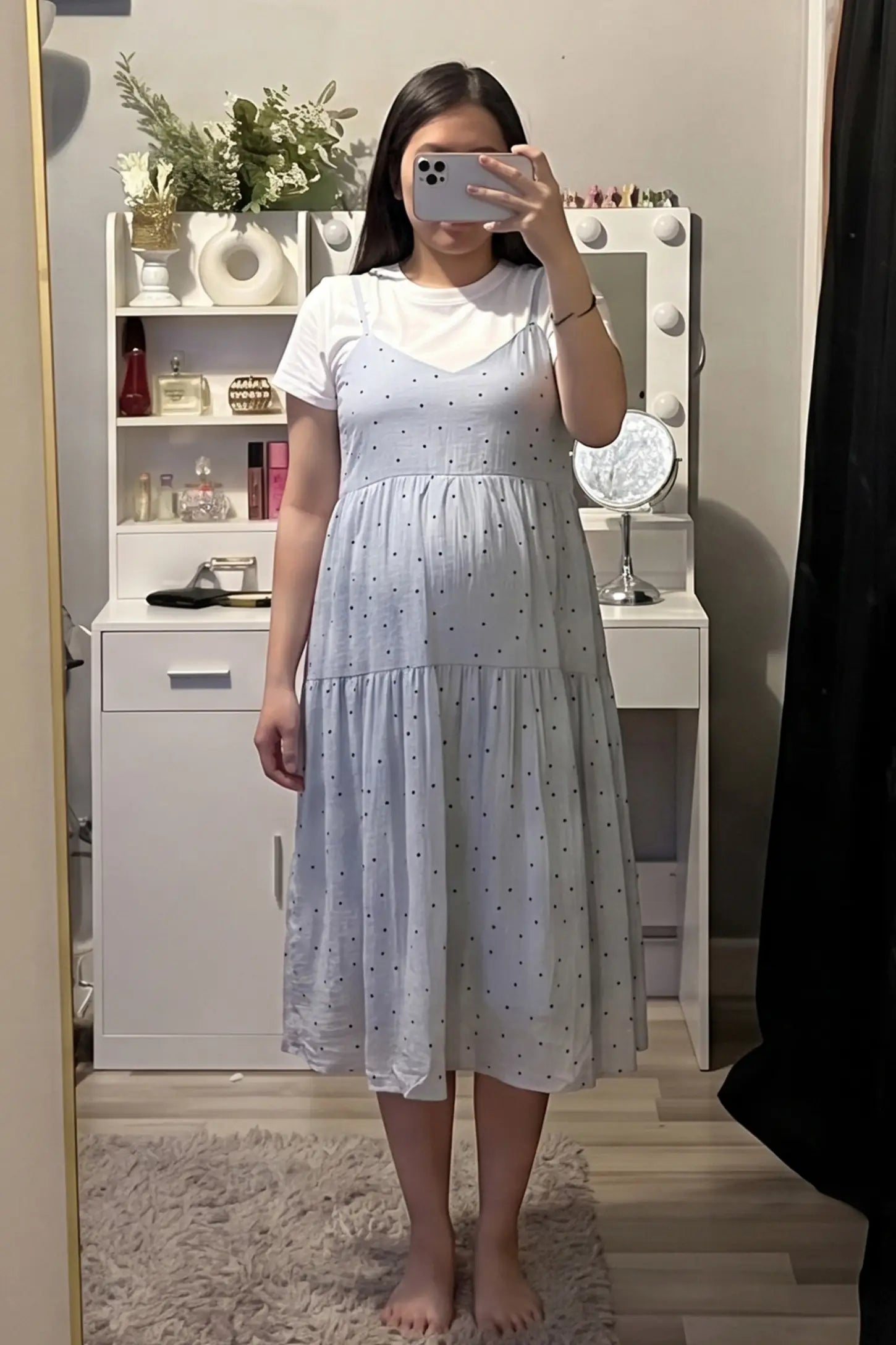 Polka Dot Round Neck Tiered Midi Maternity Dress Polka Dot Round Neck Tiered Midi Maternity Dress in Blue featuring a soft tiered skirt layered over a white round-neck tee on a pregnant model, mirror selfie view.
