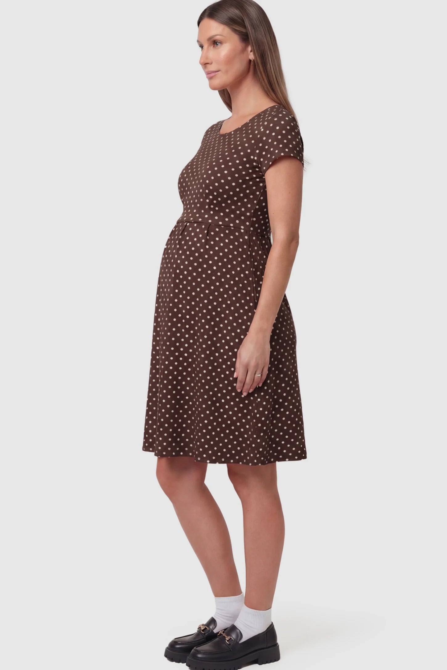 Polka Dot Scoop Neck Maternity Nursing Dress Polka Dot Scoop Neck Midi Maternity Nursing Dress in brown featuring a discreet lift-up layer on a pregnant model showing side.