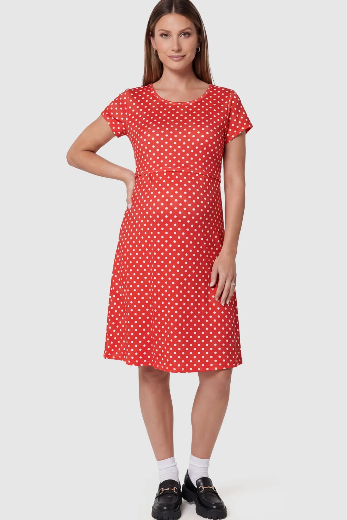 Polka Dot Scoop Neck Maternity Nursing Dress Polka Dot Scoop Neck Midi Maternity Nursing Dress in red featuring a discreet lift-up layer on a pregnant model showing front.