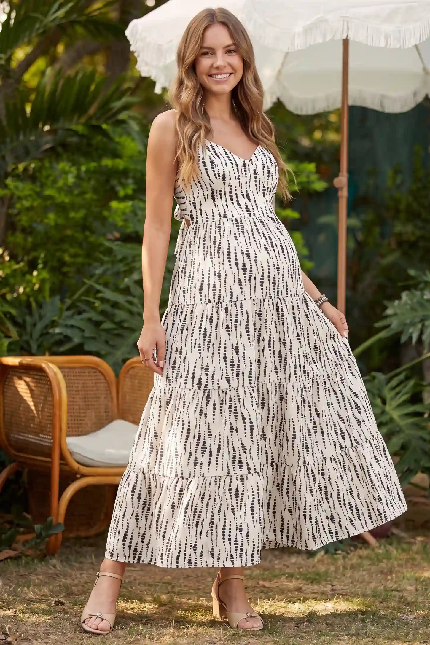 Print Tiered Cami Maternity Maxi Dress Print Tiered Cami Maternity Maxi Dress in Ivory Dash Print featuring cami straps and a tiered maxi skirt, front view on a pregnant model.