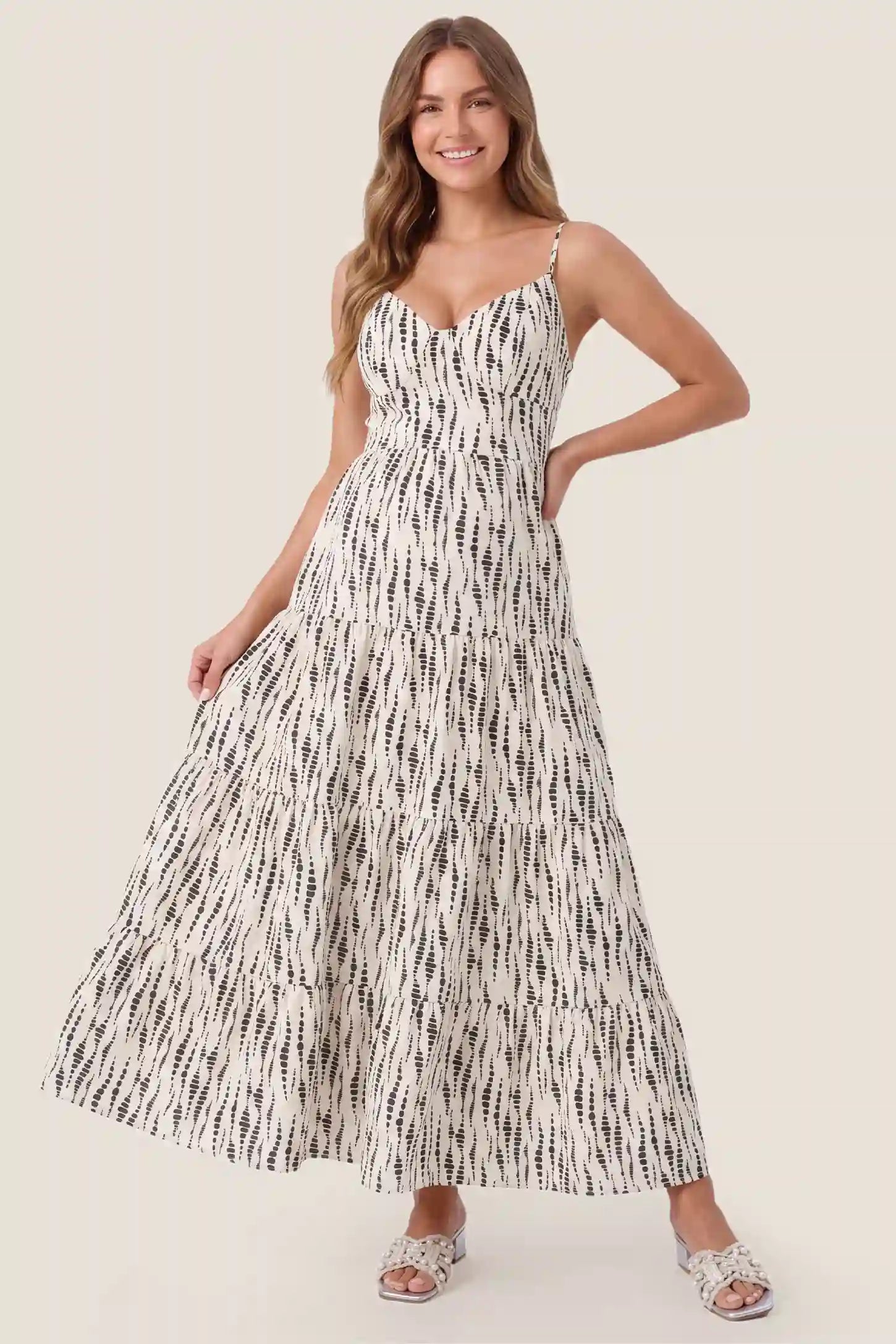 Print Tiered Cami Maternity Maxi Dress Print Tiered Cami Maternity Maxi Dress in Ivory Dash Print featuring cami straps and a tiered maxi skirt, front view on a pregnant model.