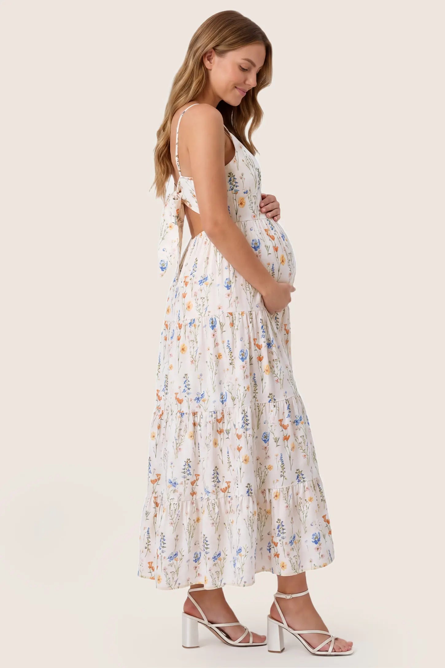 Print Tiered Cami Maternity Maxi Dress Print Tiered Cami Maternity Maxi Dress in White showing the A-line flow over the belly, side view on a pregnant model.