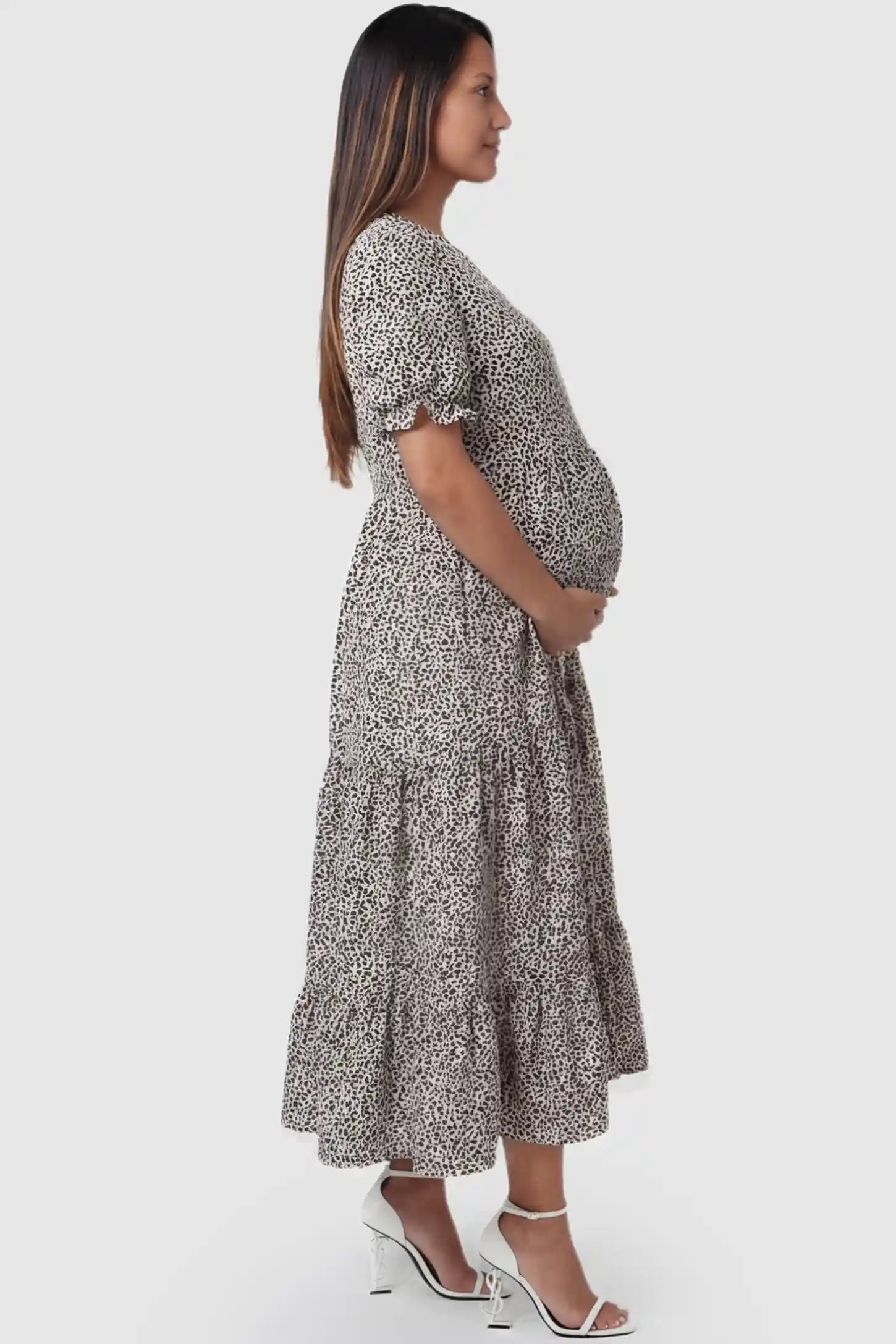 Printed Short Sleeve Tiered Maternity Midi Dress Printed Short Sleeve Tiered Maternity Midi Dress in apricot featuring round neck, tiered A-line skirt on a pregnant model, side view.