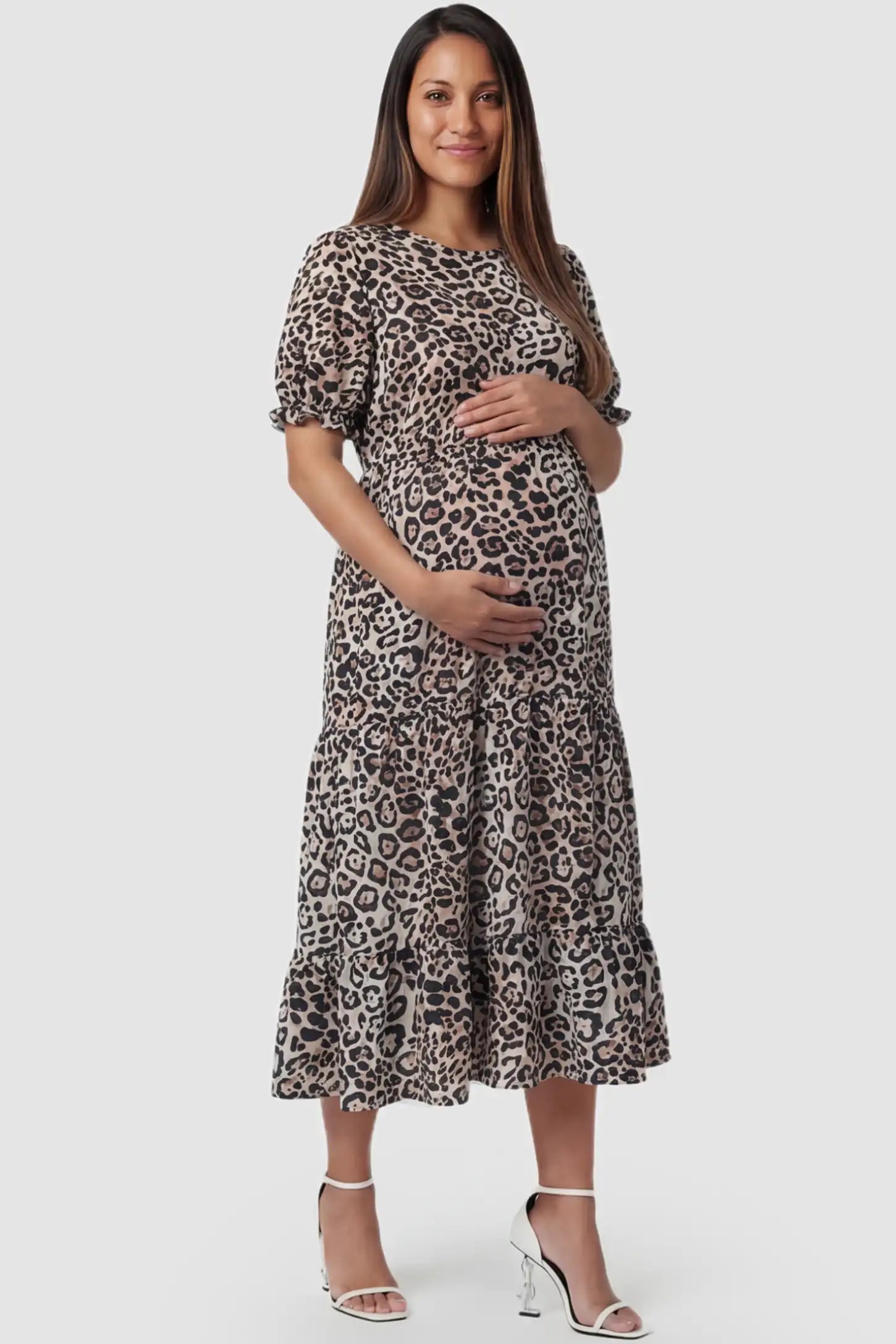 Printed Short Sleeve Tiered Maternity Midi Dress Printed Short Sleeve Tiered Maternity Midi Dress in leopard print featuring round neck, tiered A-line skirt on a pregnant model, front view.