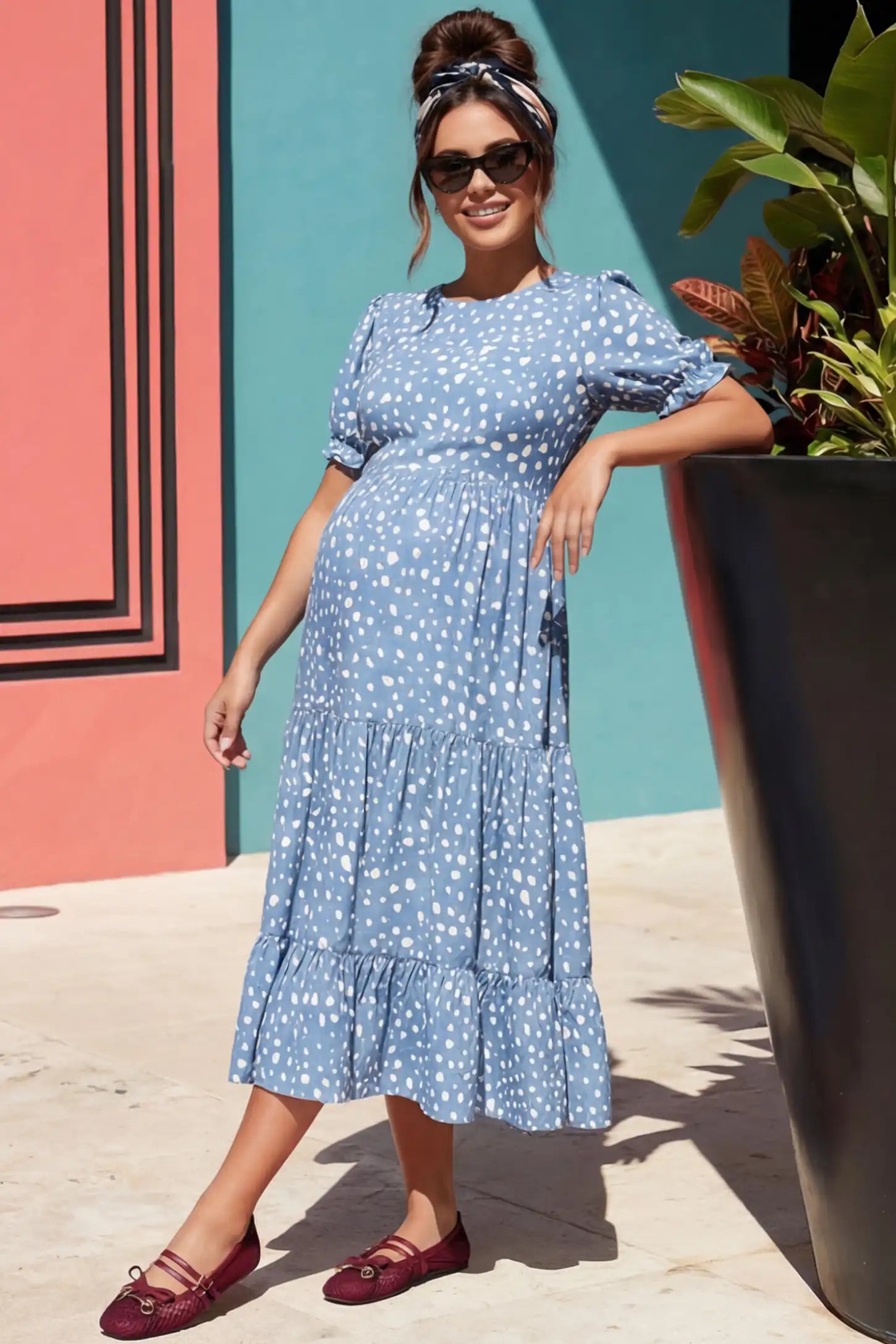 Printed Short Sleeve Tiered Maternity Midi Dress Printed Short Sleeve Tiered Maternity Midi Dress in light blue featuring round neck, tiered A-line skirt on a pregnant woman in outdoor setting, front view.