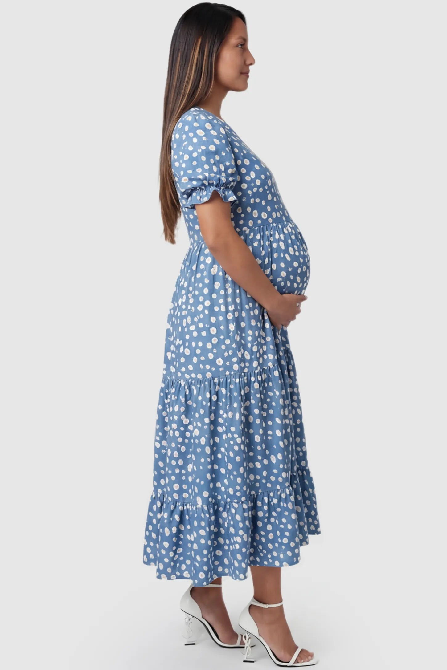 Printed Short Sleeve Tiered Maternity Midi Dress Printed Short Sleeve Tiered Maternity Midi Dress in light blue featuring round neck, tiered A-line skirt on a pregnant model, side view.