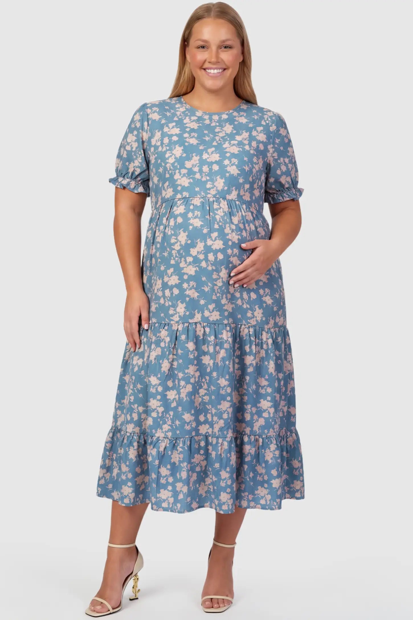 Printed Short Sleeve Tiered Maternity Midi Dress Printed Short Sleeve Tiered Maternity Midi Dress in ocean blue featuring round neck, tiered A-line skirt on a plus size pregnant model, front view.