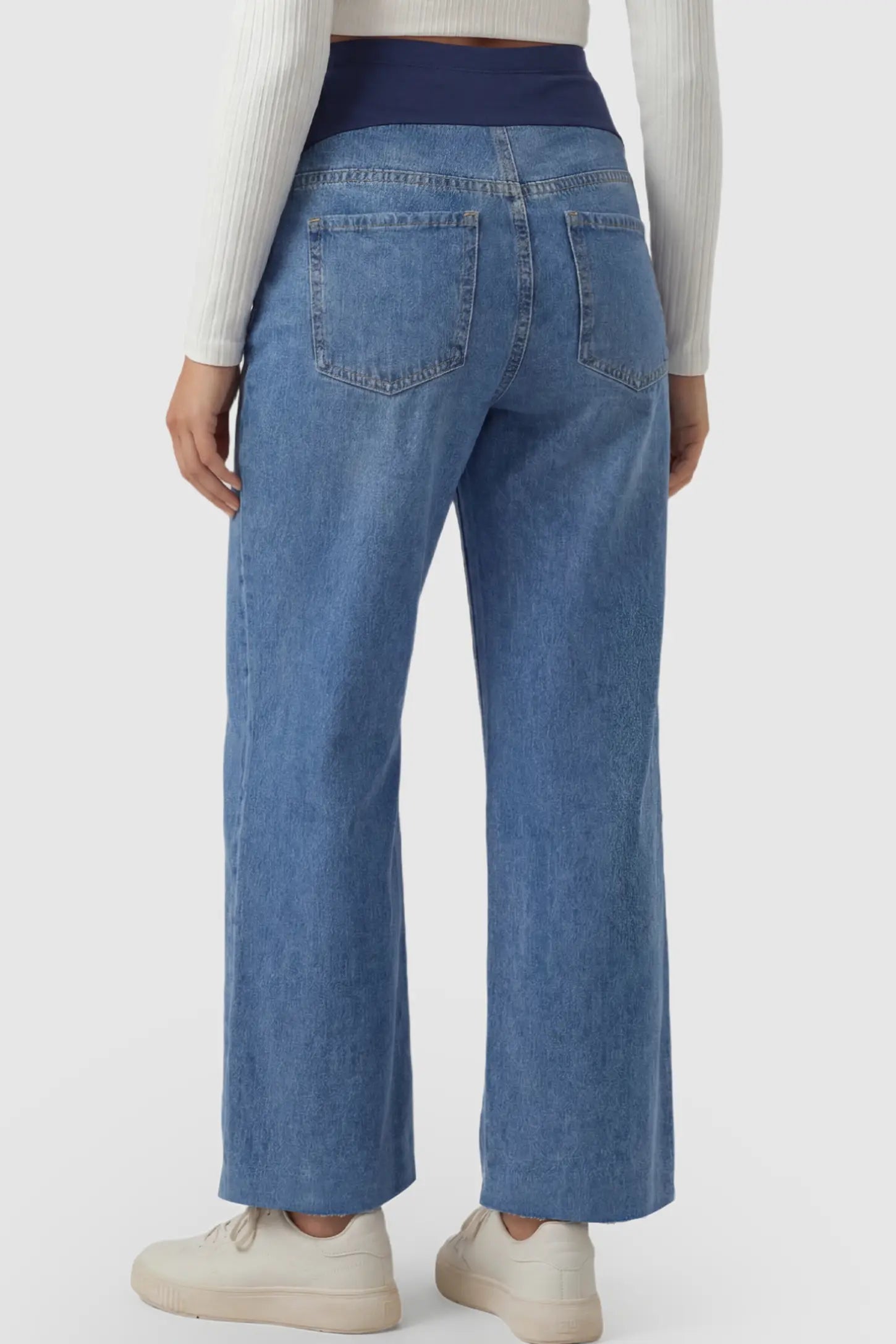 Raw Hem Full Panel Wide Leg Maternity Jeans Raw Hem Full Panel Wide Leg Maternity Jeans in dark blue featuring a high-rise navy belly band on a pregnant model showing back.