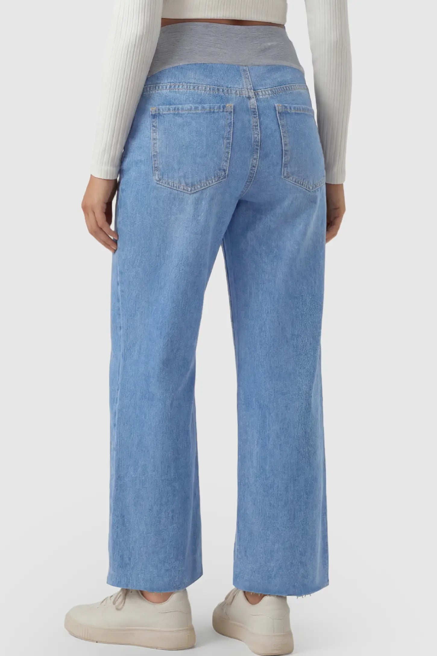 Raw Hem Full Panel Wide Leg Maternity Jeans Raw Hem Full Panel Wide Leg Maternity Jeans in light blue featuring a high-rise navy belly band on a pregnant model showing back.