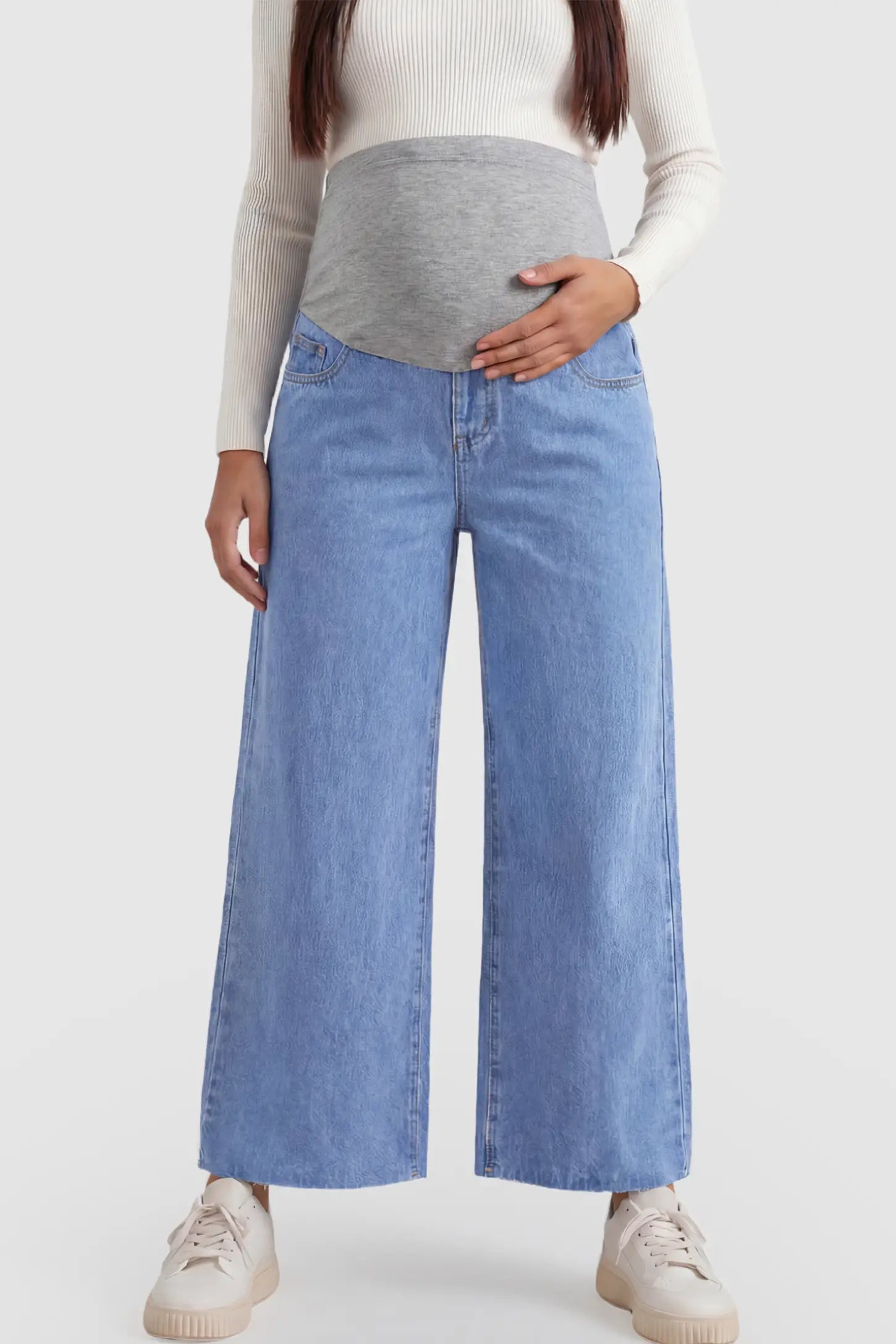 Raw Hem Full Panel Wide Leg Maternity Jeans Raw Hem Full Panel Wide Leg Maternity Jeans in light blue featuring a high-rise navy belly band on a pregnant model showing front.