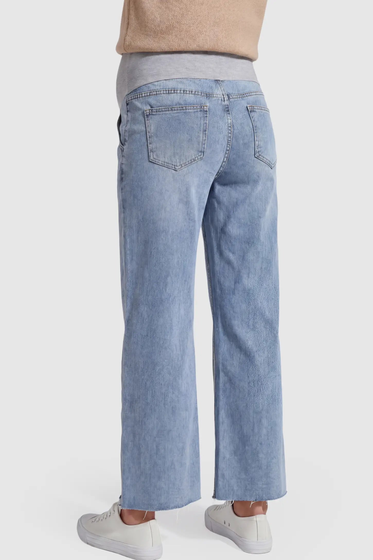 Raw Hem Wide Leg Maternity Jeans Raw Hem Wide Leg Maternity Jeans in Light Blue Denim featuring raw hem on a pregnant model showing back.
