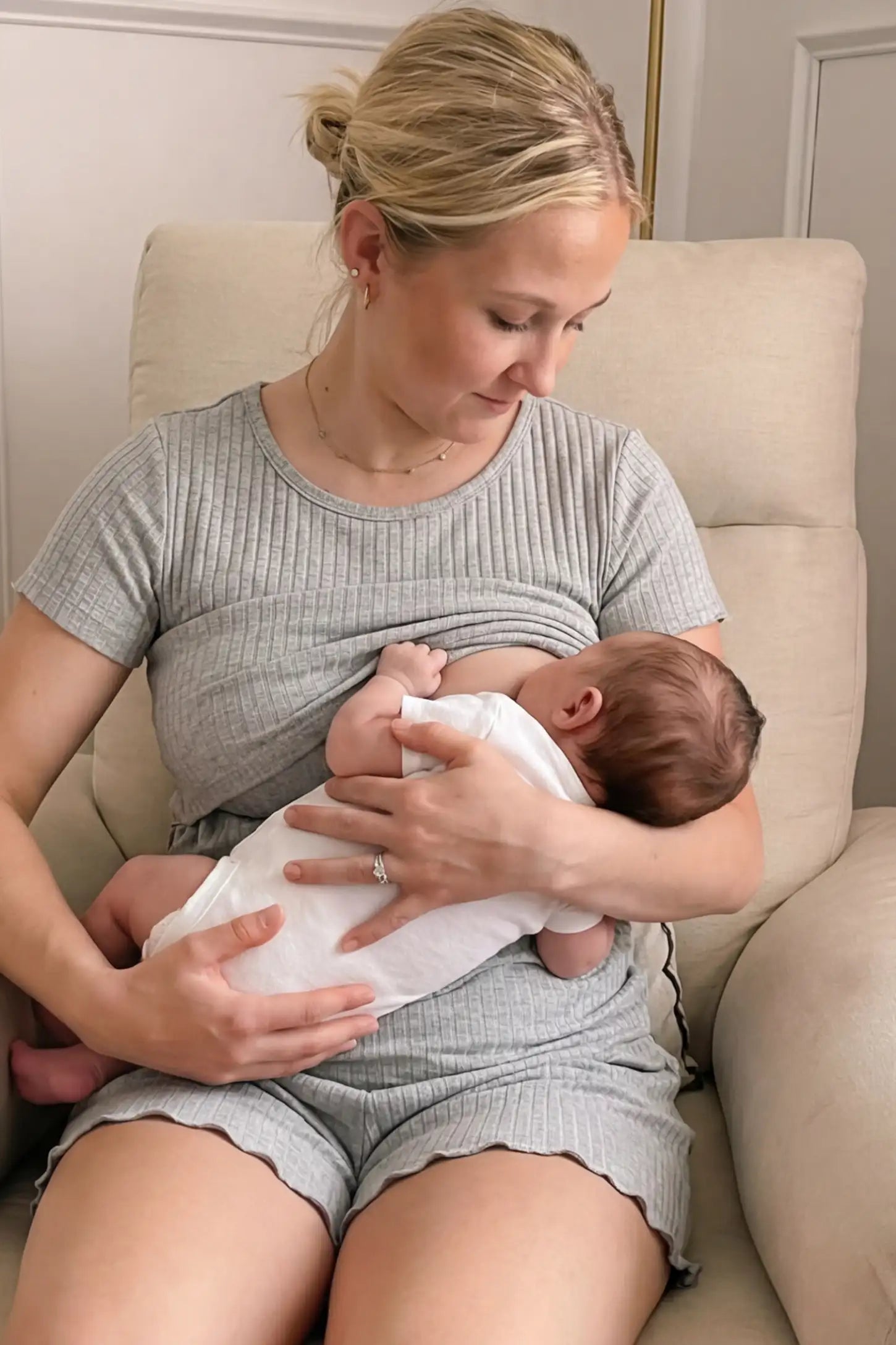 Ribbed Short Sleeve Top & Drawstring Shorts Maternity Nursing Lounge Set Ribbed Maternity and Nursing Pajama Set in gray featuring functional lift-up nursing layers while breastfeeding a newborn, front view.
