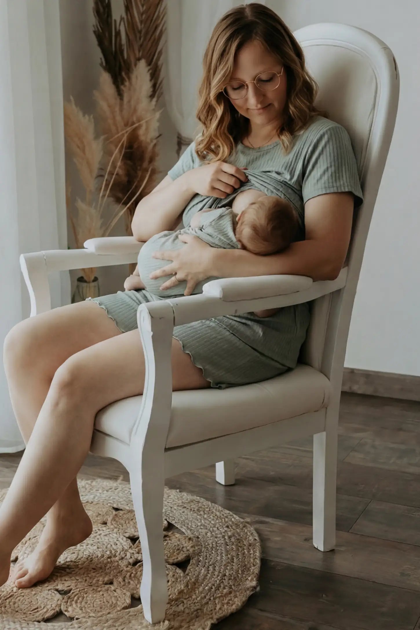 Ribbed Short Sleeve Top & Drawstring Shorts Maternity Nursing Lounge Set Ribbed Maternity and Nursing Pajama Set in green featuring functional lift-up nursing layers while breastfeeding a newborn, side view.