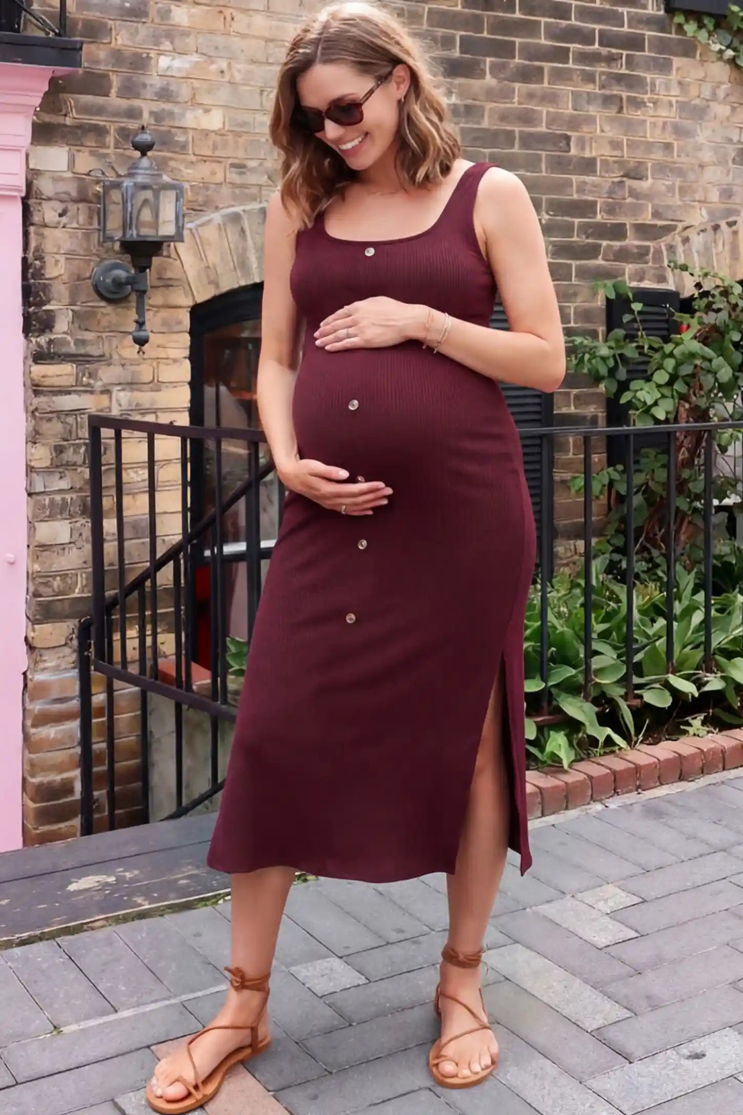 Ribbed Button Accent Side Slit Maternity Midi Dress in Burgundy featuring a flexible knit and decorative buttons on a pregnant model showing front.