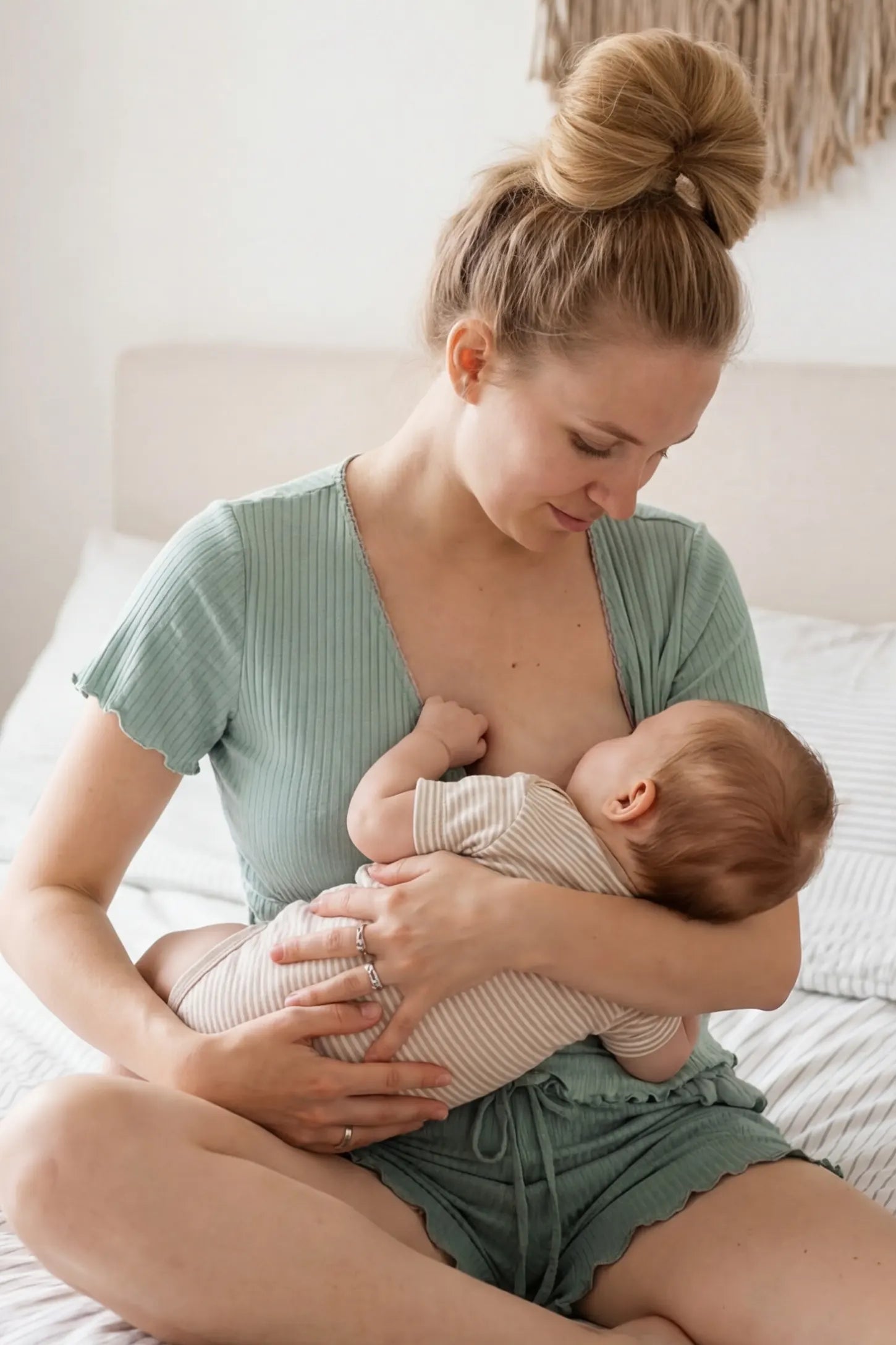 Ribbed Short Sleeve & Drawstring Shorts Maternity Pajama Set Ribbed Short Sleeve & Drawstring Shorts Maternity Pajama Set in Green featuring an intimate seated nursing moment on a non-pregnant model, editorial lifestyle view.