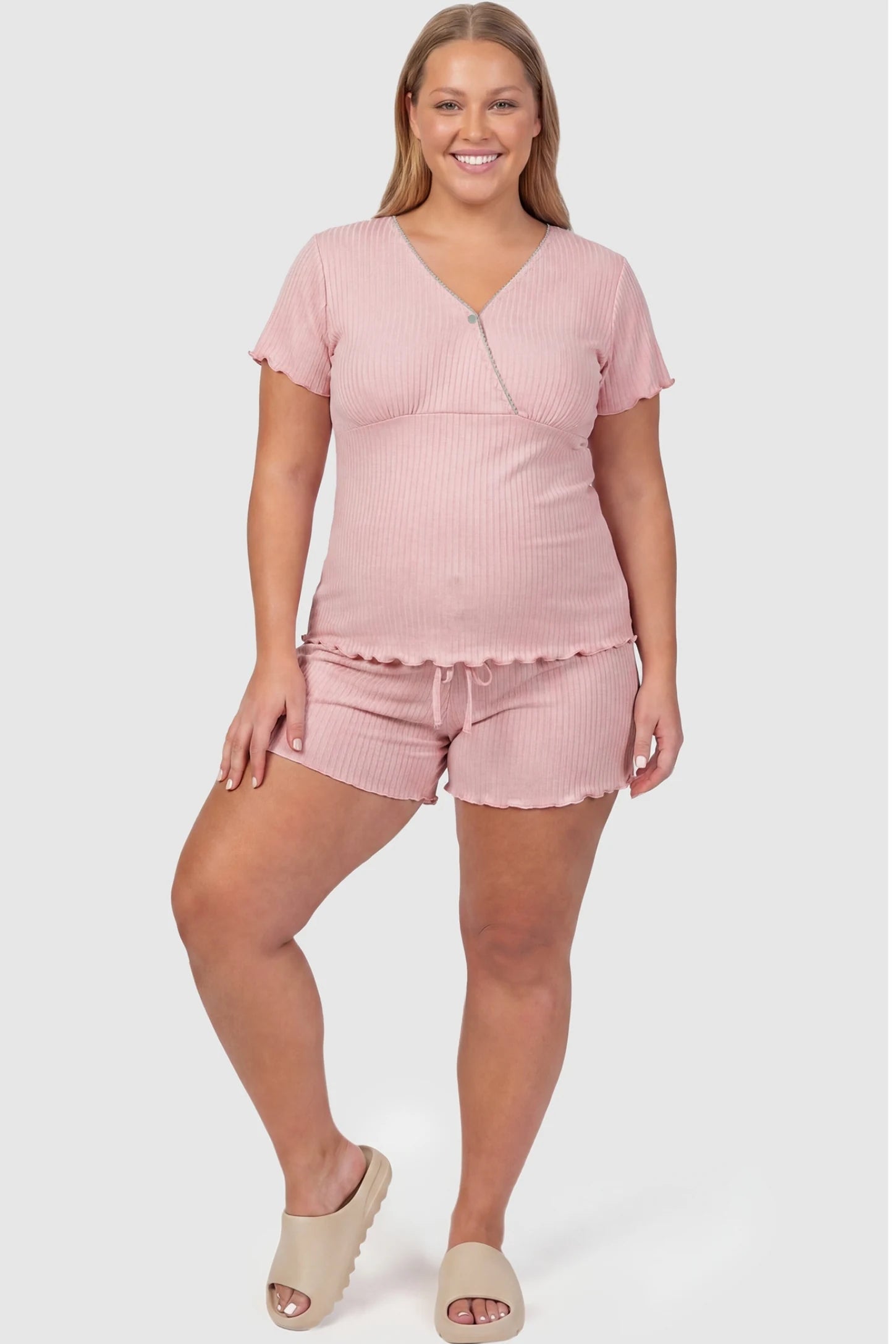 Ribbed Short Sleeve & Drawstring Shorts Maternity Pajama Set Ribbed Short Sleeve & Drawstring Shorts Maternity Pajama Set in Pink featuring a flattering empire seam on a pregnant model, plus size front view.