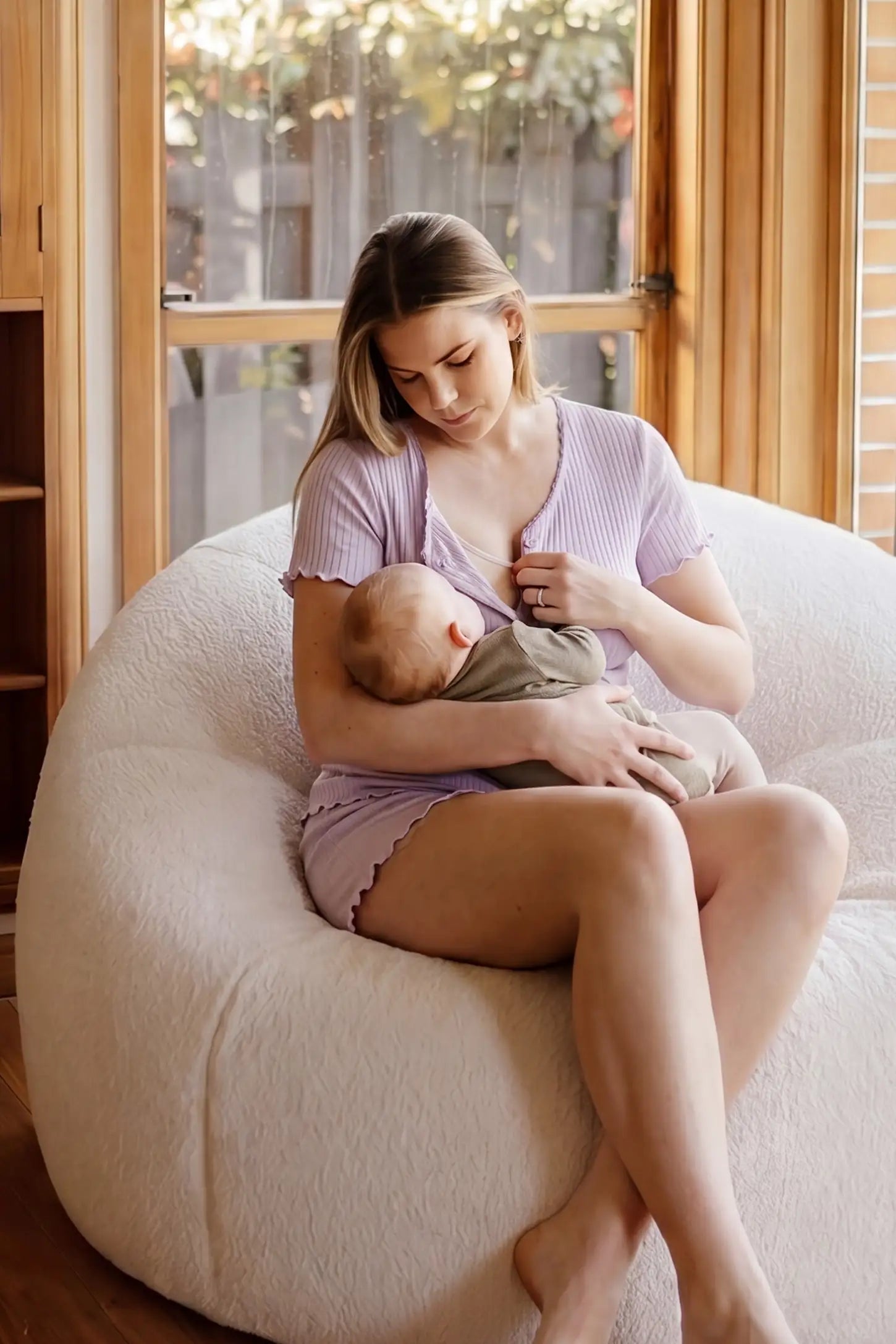 Ribbed Short Sleeve & Drawstring Shorts Maternity Pajama Set Ribbed Short Sleeve & Drawstring Shorts Maternity Pajama Set in Purple featuring a cozy seated nursing moment on a non-pregnant model, editorial lifestyle view.