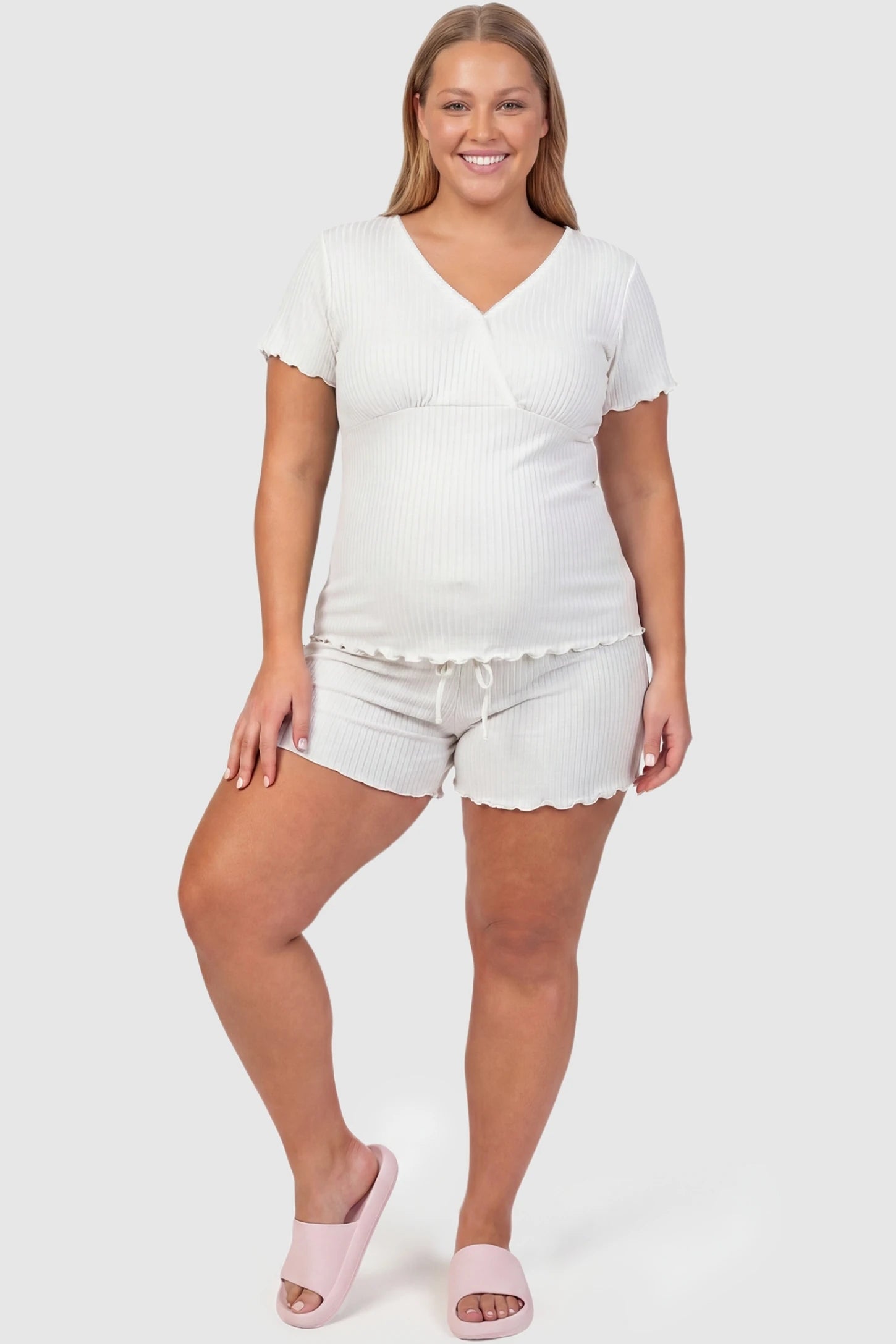 Ribbed Short Sleeve & Drawstring Shorts Maternity Pajama Set Ribbed Short Sleeve & Drawstring Shorts Maternity Pajama Set in White featuring a soft ribbed cross-over top on a pregnant model, plus size front view.
