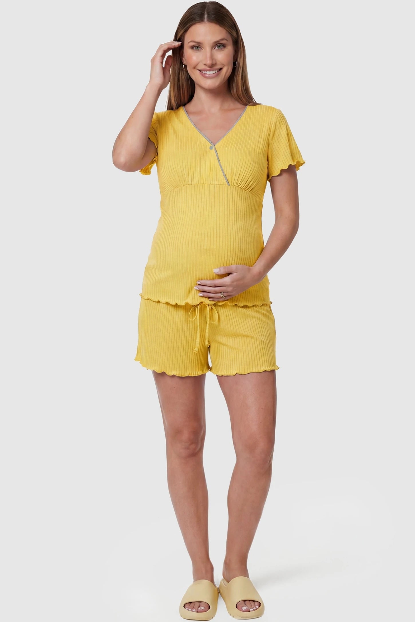 Ribbed Short Sleeve & Drawstring Shorts Maternity Pajama Set Ribbed Short Sleeve & Drawstring Shorts Maternity Pajama Set in Yellow featuring a soft ribbed cross-over top on a pregnant model, front view.