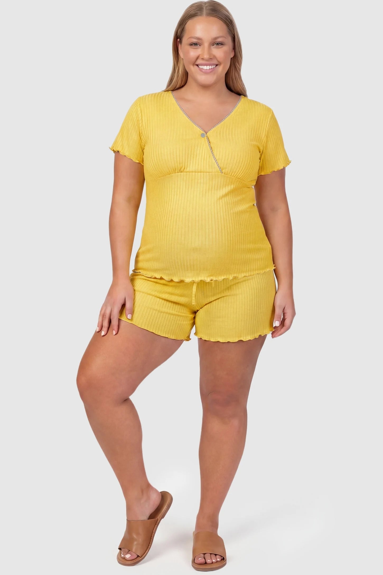 Ribbed Short Sleeve & Drawstring Shorts Maternity Pajama Set Ribbed Short Sleeve & Drawstring Shorts Maternity Pajama Set in Yellow featuring a soft ribbed cross-over top on a pregnant model, plus size front view.