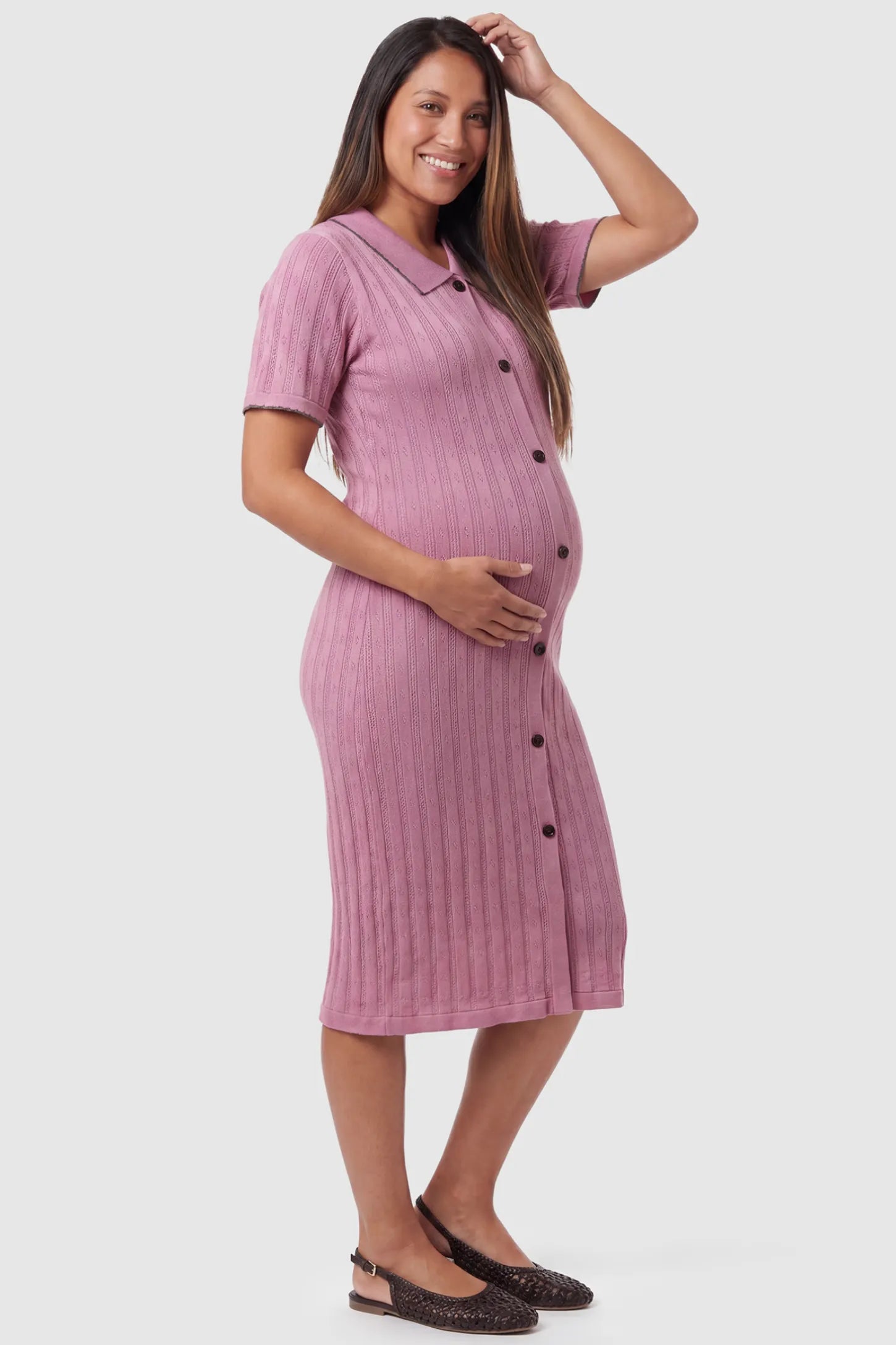 Ribbed Knit Collared Neck Maternity Midi Dress Ribbed Knit Collared Neck Maternity Midi Dress in Pink featuring short sleeves and soft knit high stretch fabric on a pregnant model, side view.