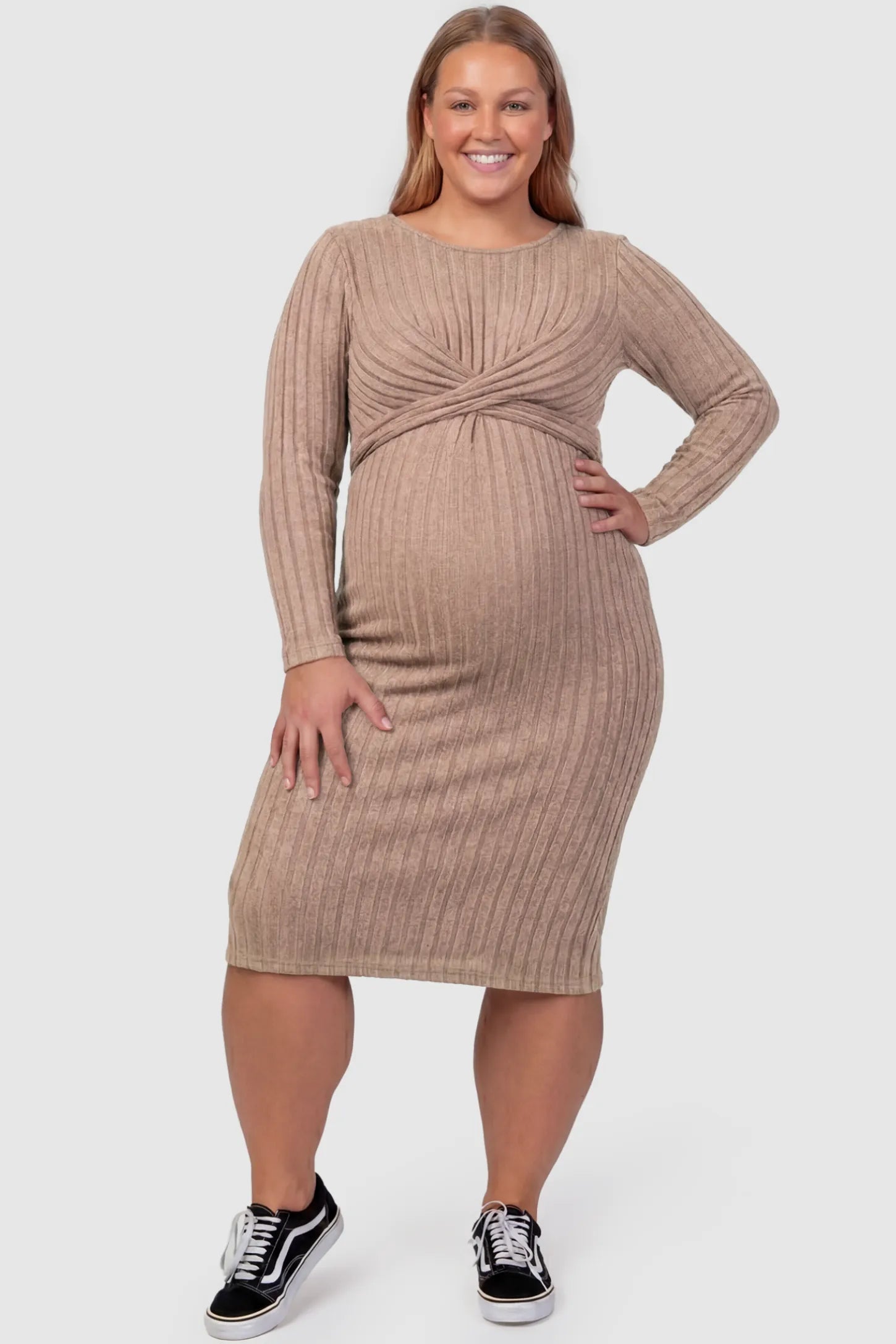 Ribbed Knit Cross Front Fitted Maternity Midi Dress Ribbed Knit Cross Front Fitted Maternity Midi Dress in Brown featuring a supportive criss-cross bodice on a plus size pregnant model, front view.