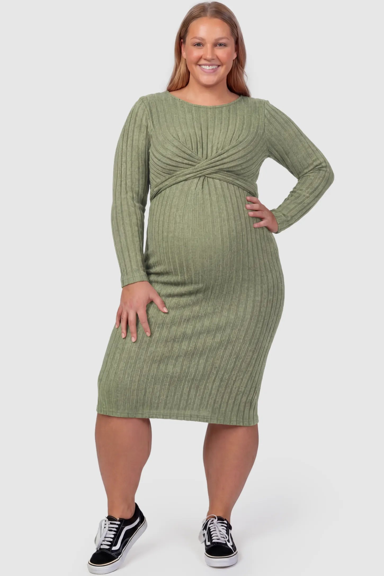 Ribbed Knit Cross Front Fitted Maternity Midi Dress Ribbed Knit Cross Front Fitted Maternity Midi Dress in Green featuring a supportive criss-cross bodice on a plus size pregnant model, front view.