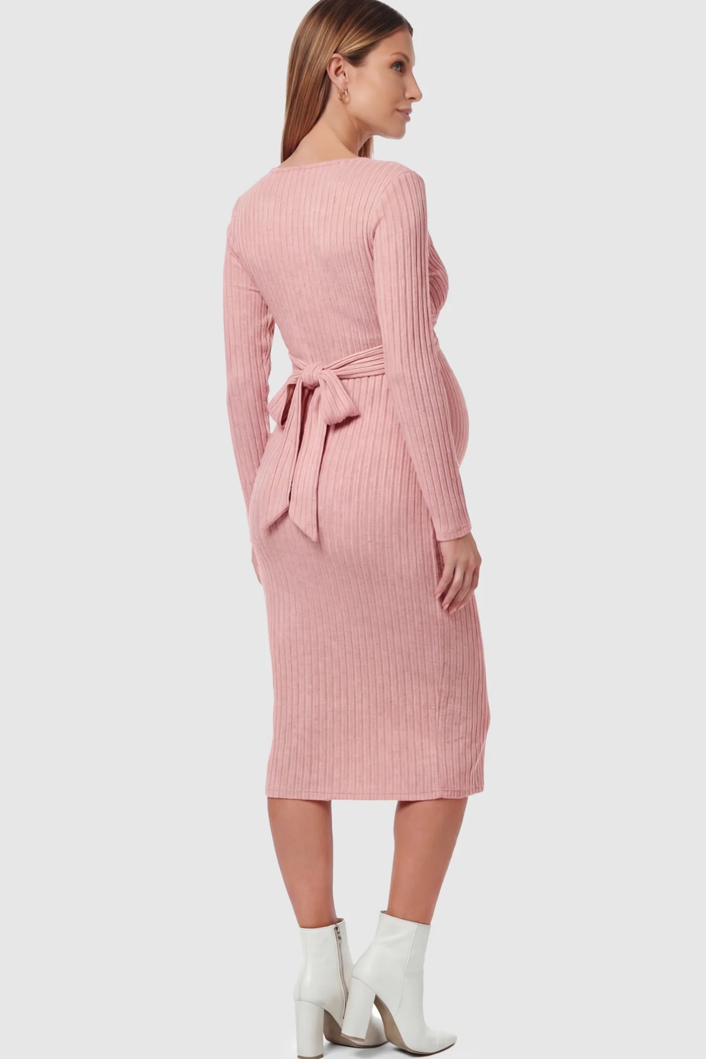 Ribbed Knit Cross Front Fitted Maternity Midi Dress Ribbed Knit Cross Front Fitted Maternity Midi Dress in Pink featuring a back waist-tie on a pregnant model.