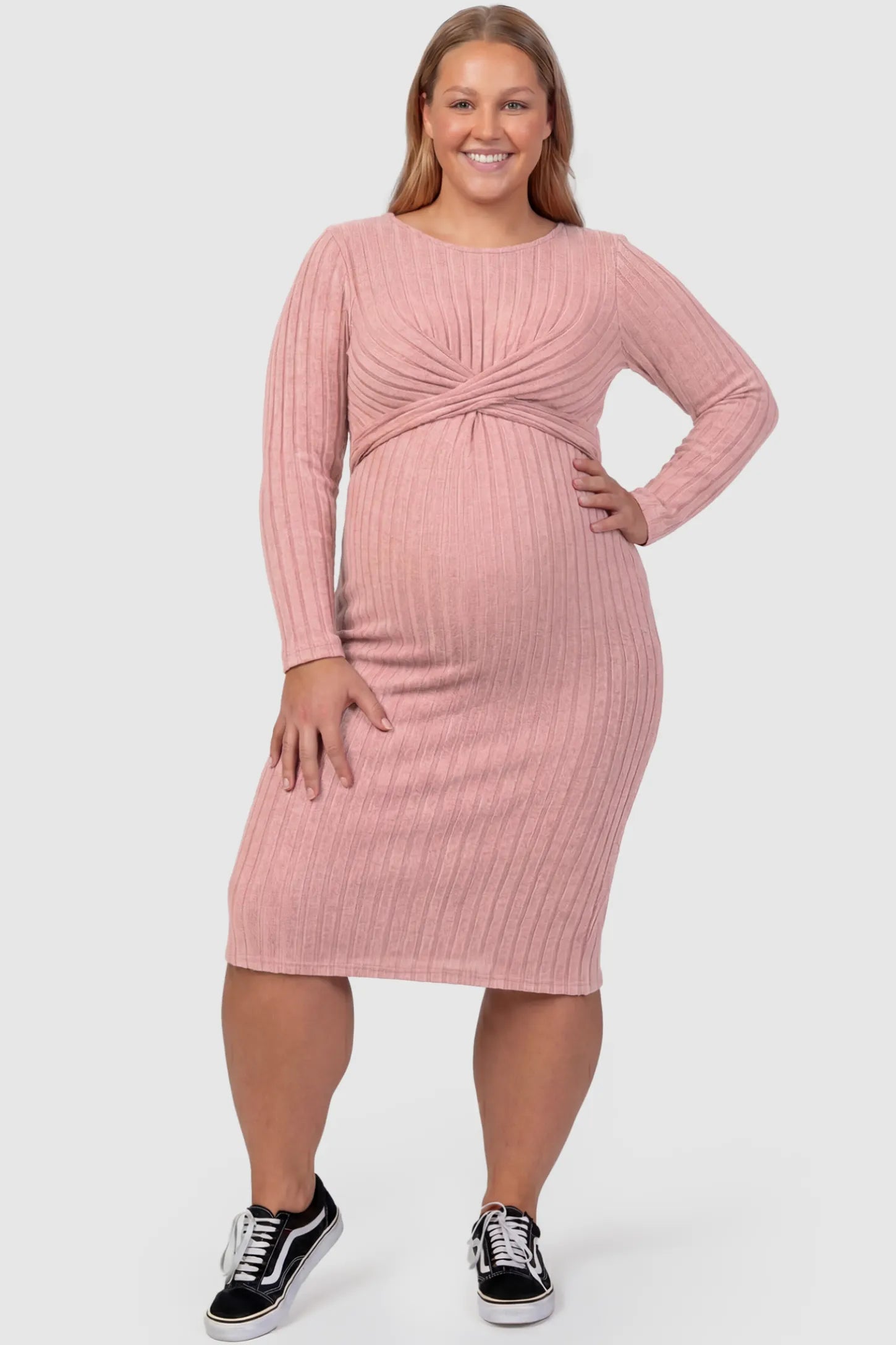 Ribbed Knit Cross Front Fitted Maternity Midi Dress Ribbed Knit Cross Front Fitted Maternity Midi Dress in Pink featuring a supportive criss-cross bodice on a plus size pregnant model, front view.