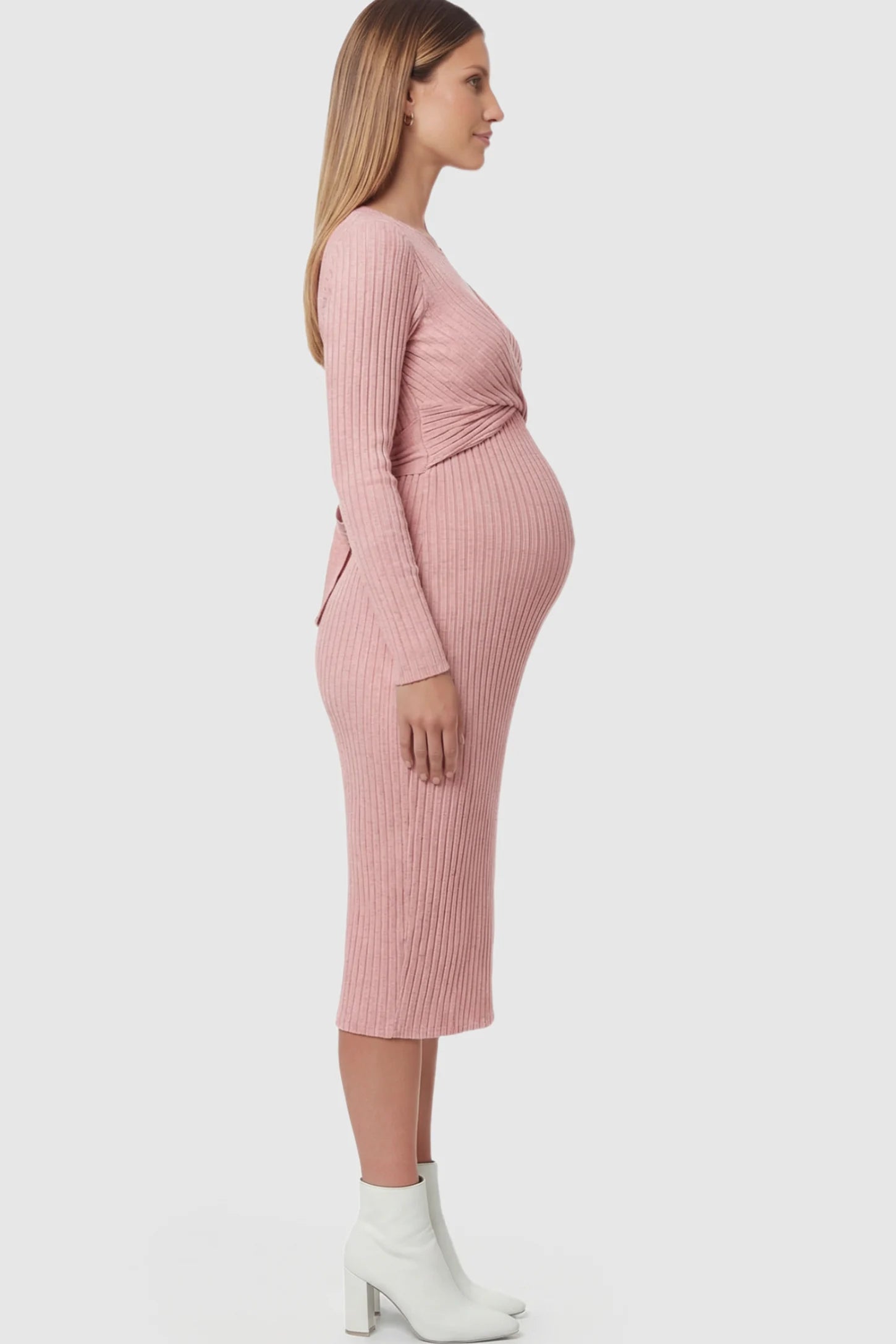 Ribbed Knit Cross Front Fitted Maternity Midi Dress Ribbed Knit Cross Front Fitted Maternity Midi Dress in Pink featuring a supportive criss-cross bodice on a pregnant model.