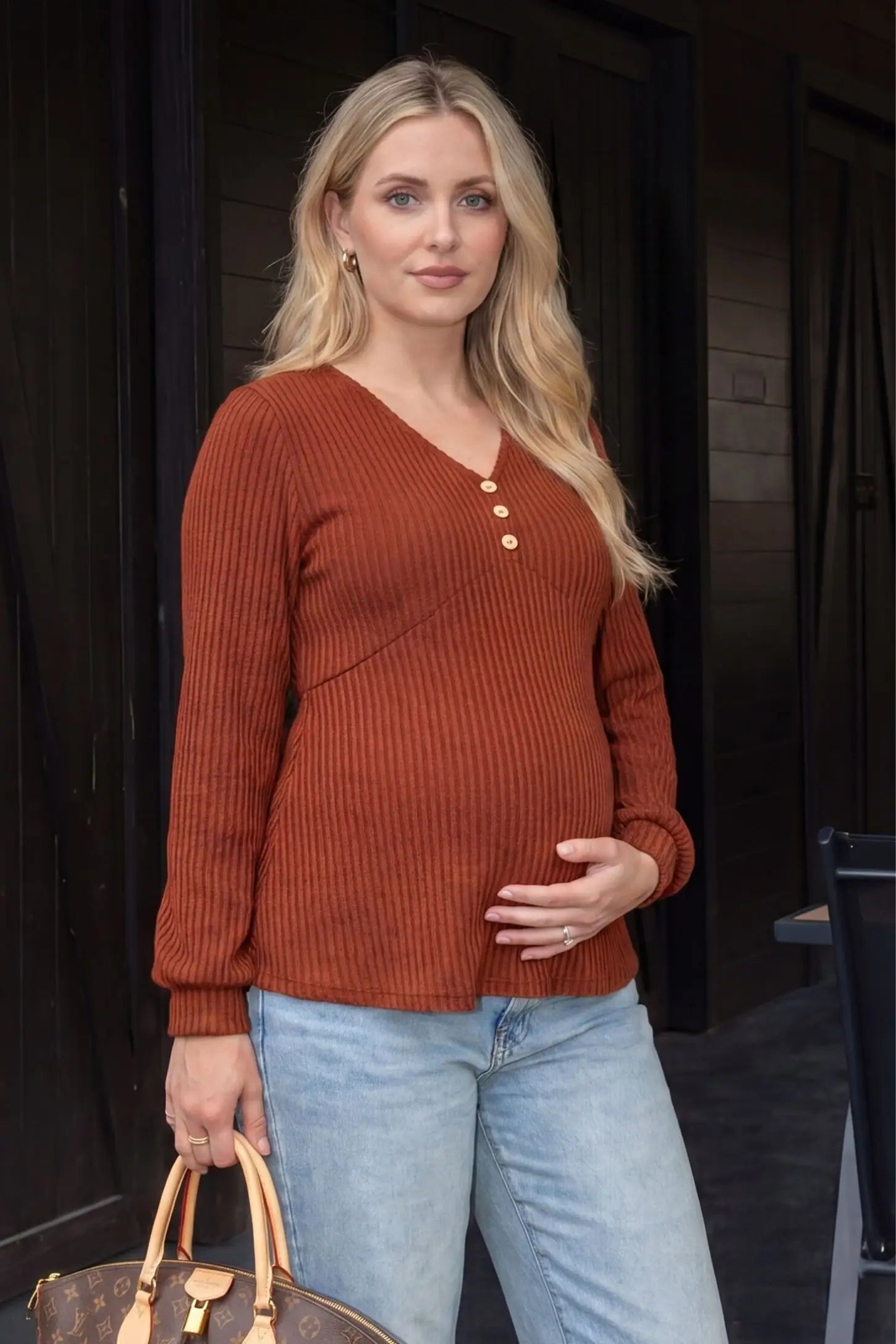 Ribbed Knit Empire Waist Maternity Top Ribbed Knit Empire Waist Maternity Top in brown featuring a v-neckline and ribbed knit texture on a pregnant model front view.