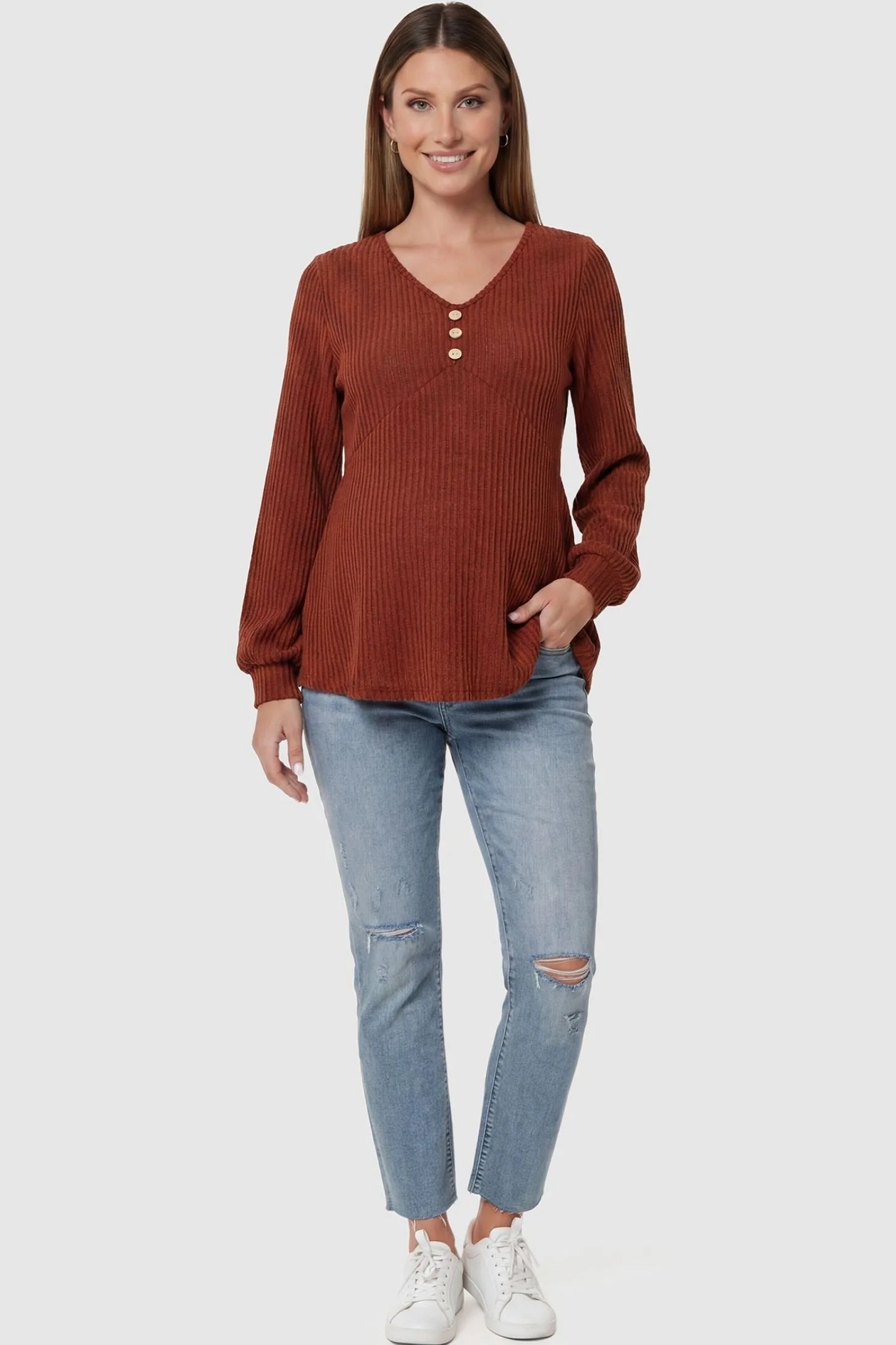 Ribbed Knit Empire Waist Maternity Top Ribbed Knit Empire Waist Maternity Top in brown featuring a v-neckline and ribbed knit texture on a pregnant model full body view.