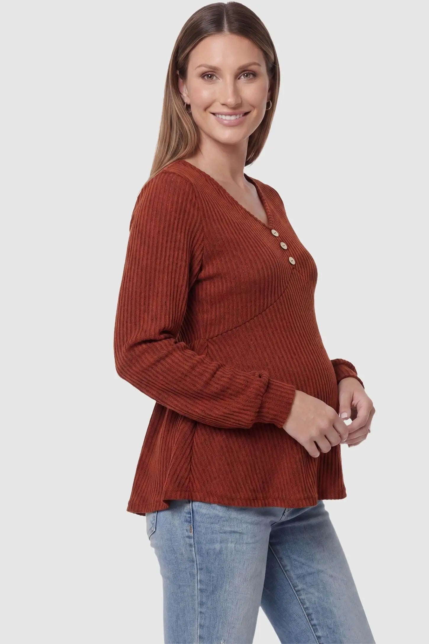 Ribbed Knit Empire Waist Maternity Top in brown featuring a v-neckline and ribbed knit texture on a pregnant model side view.