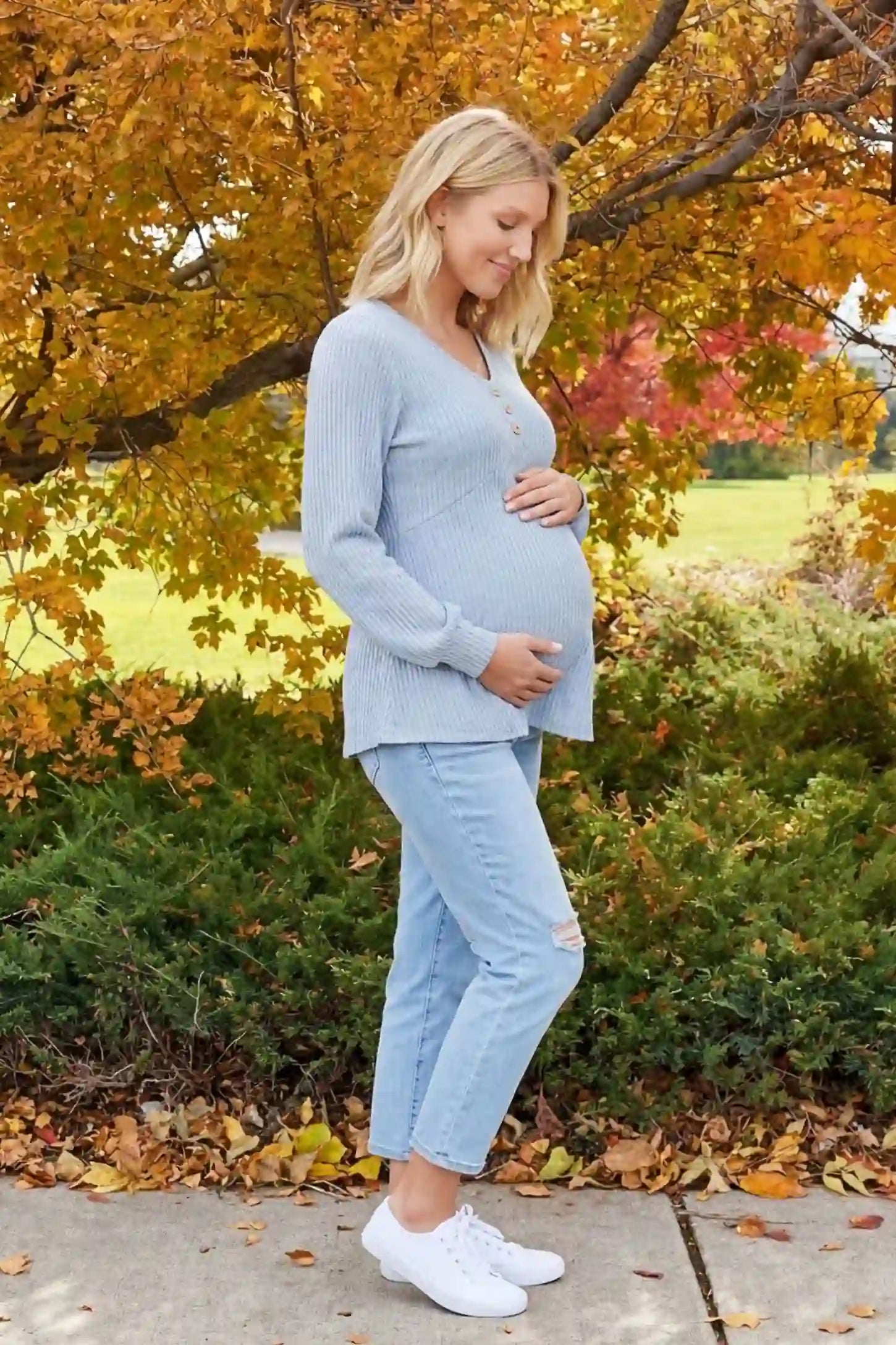 Ribbed Knit Empire Waist Maternity Top Ribbed Knit Empire Waist Maternity Top in light blue featuring a v-neckline and ribbed knit texture on a pregnant model side view.