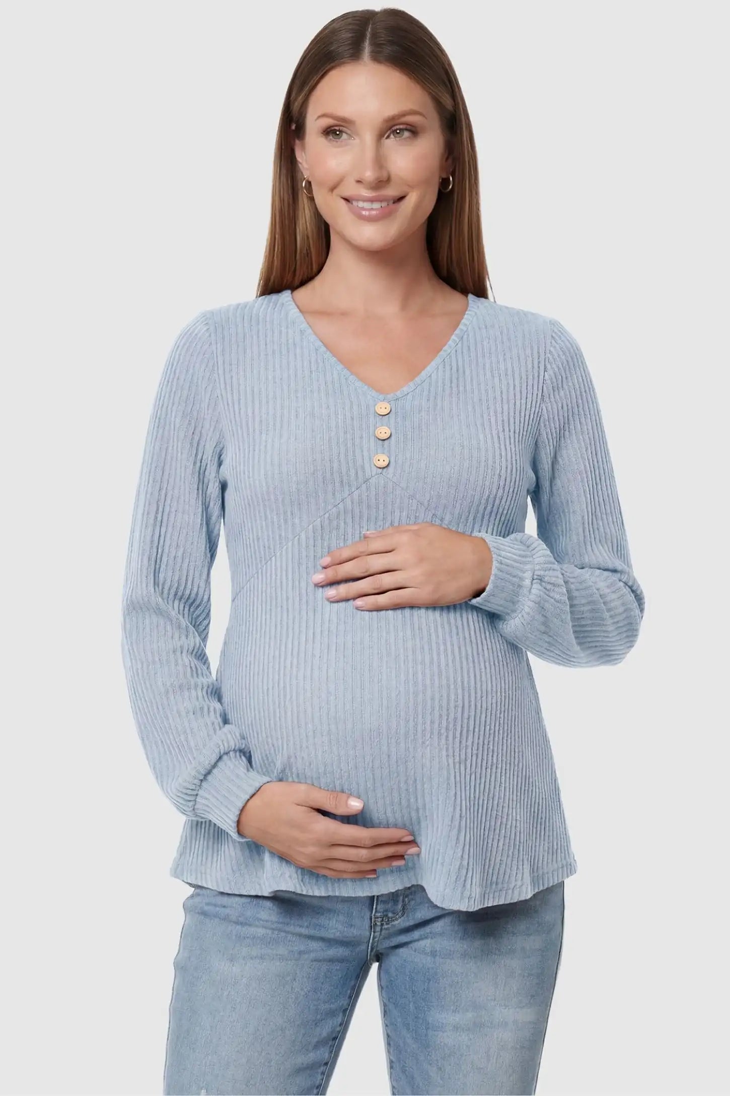 Ribbed Knit Empire Waist Maternity Top Ribbed Knit Empire Waist Maternity Top in light blue featuring a v-neckline and ribbed knit texture on a pregnant model front view.