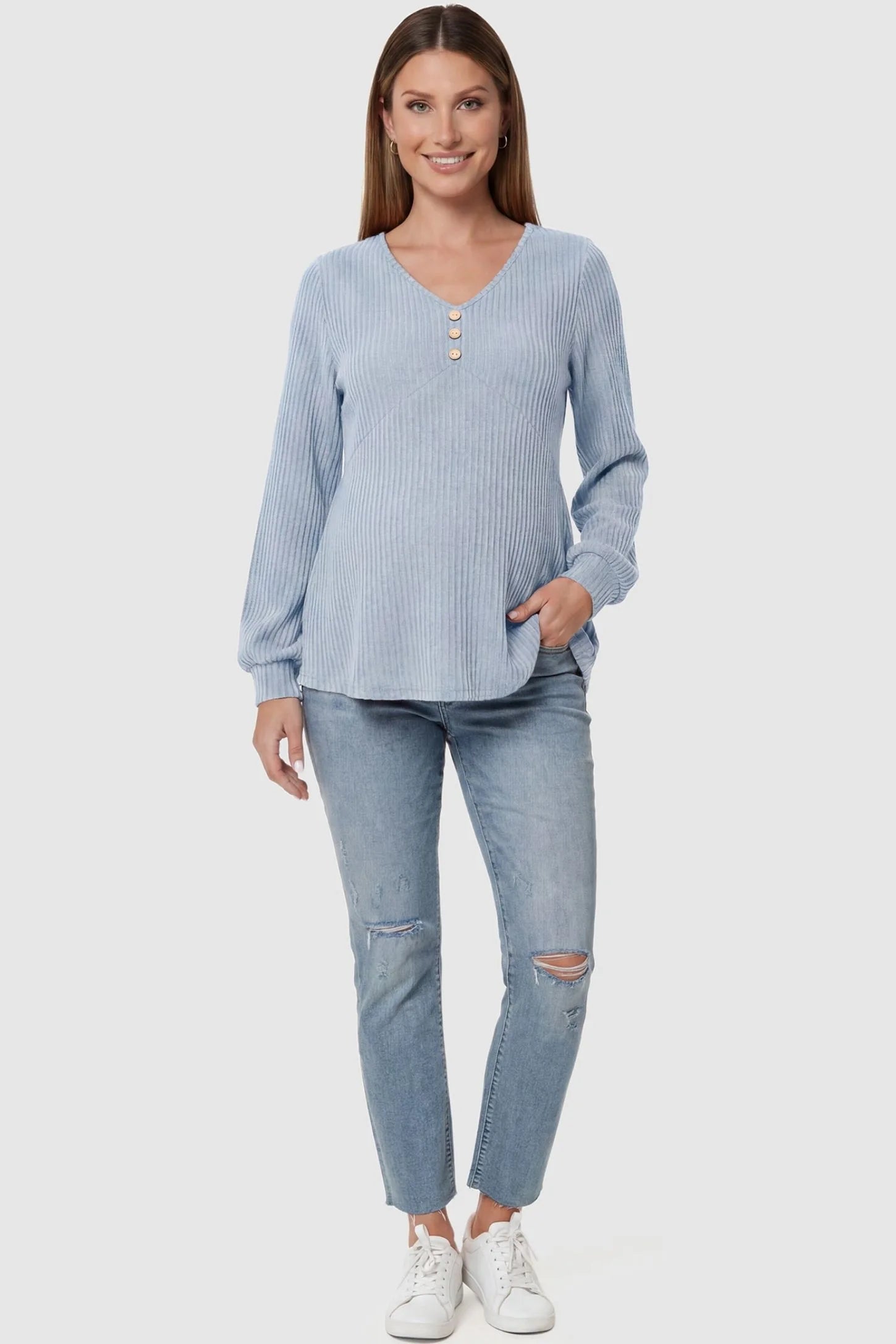 Ribbed Knit Empire Waist Maternity Top Ribbed Knit Empire Waist Maternity Top in light blue featuring a v-neckline and ribbed knit texture on a pregnant model front view.