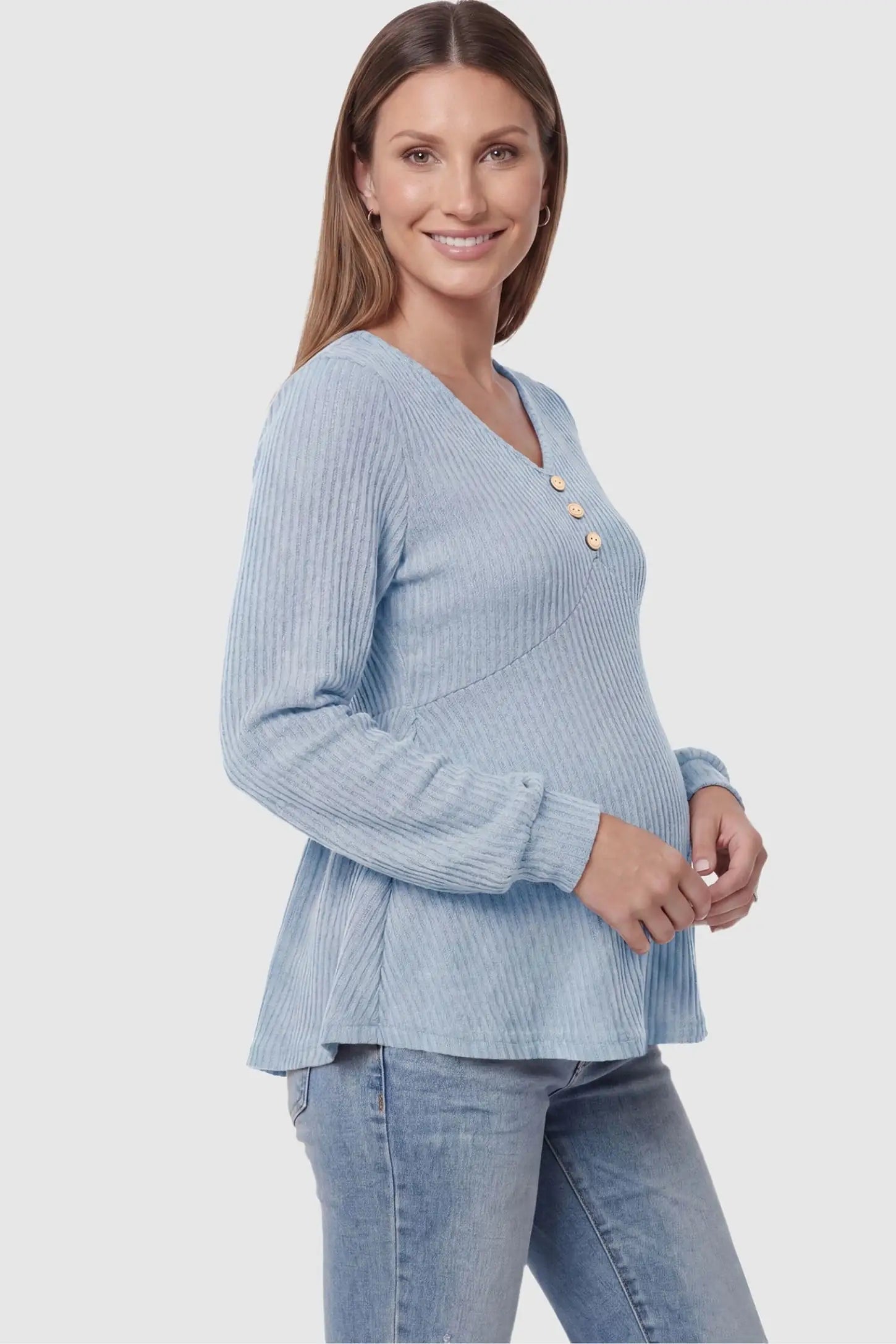 Ribbed Knit Empire Waist Maternity Top Ribbed Knit Empire Waist Maternity Top in light blue featuring a v-neckline and ribbed knit texture on a pregnant model side view.
