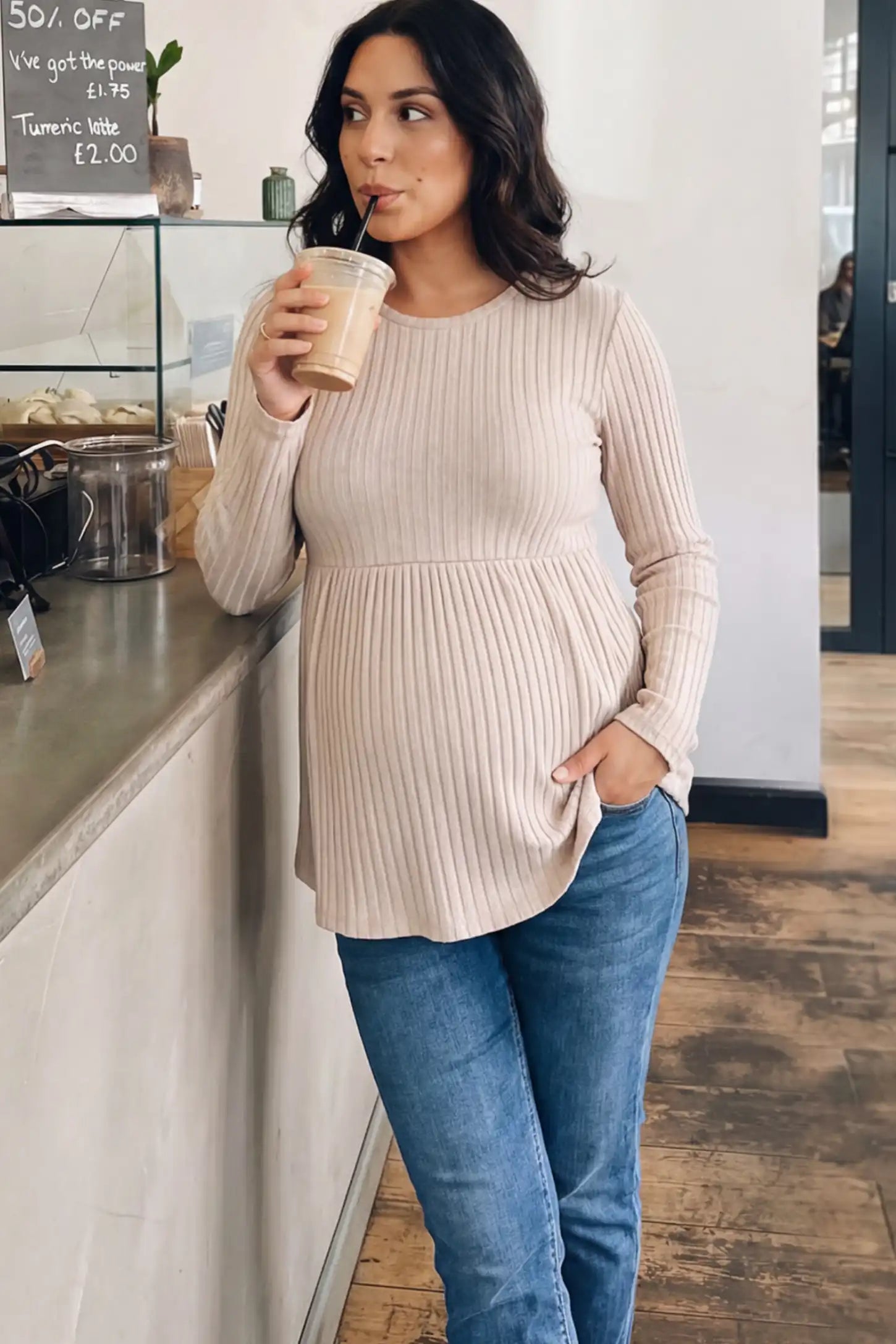 Ribbed Knit Long Sleeve Maternity Top Ribbed Knit Long Sleeve Maternity Top in Beige featuring an empire waist and high-stretch fabric on a pregnant woman.