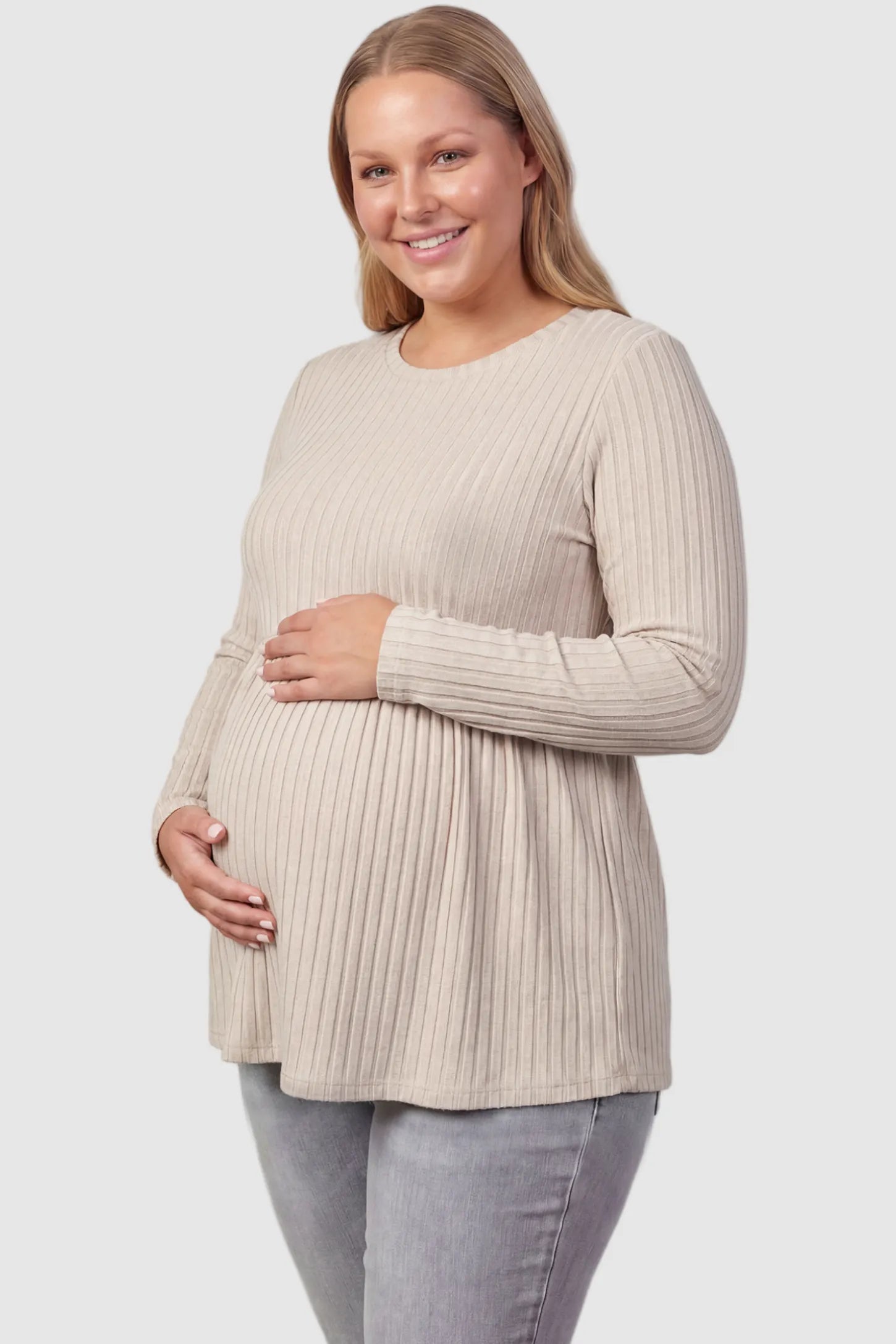 Ribbed Knit Long Sleeve Maternity Top Ribbed Knit Long Sleeve Maternity Top in Beige featuring an empire waist and high-stretch fabric on a plus size pregnant model, front view.