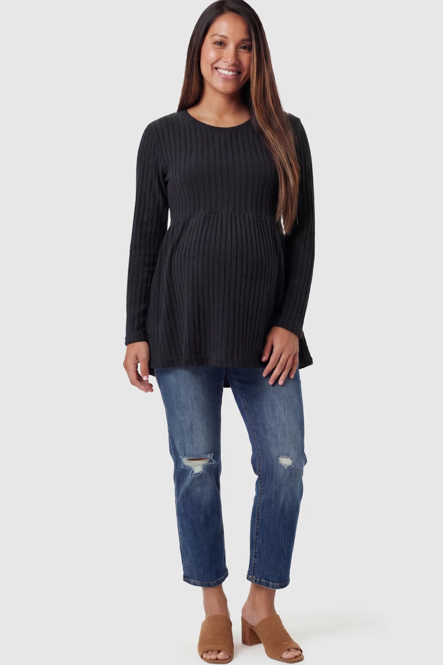 Ribbed Knit Long Sleeve Maternity Top Ribbed Knit Long Sleeve Maternity Top in black featuring an empire waist and high-stretch fabric on a pregnant model.